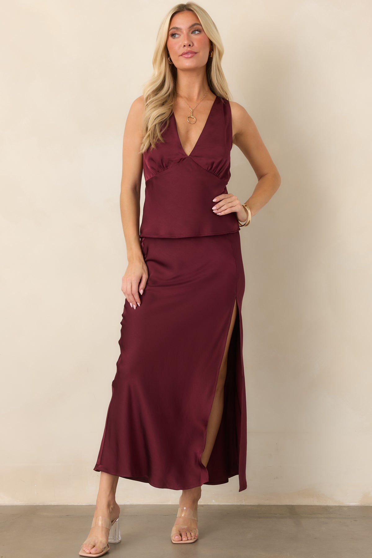 Rich wine satin top featuring an empire waist seam and graceful drape through the bodice.