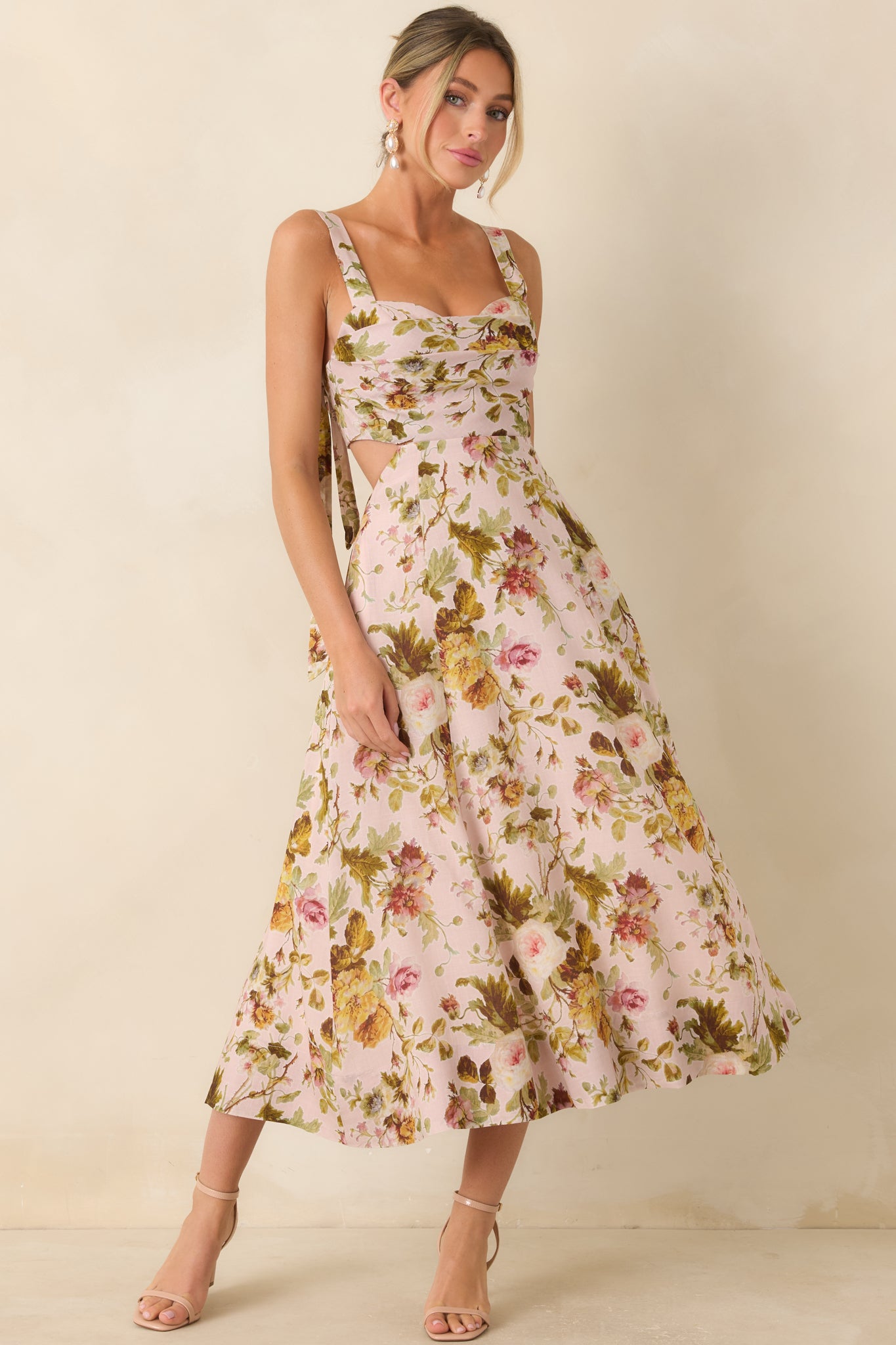 Romantic floral midi dress highlighting a structured neckline, flowing silhouette, and delicate botanical pattern.