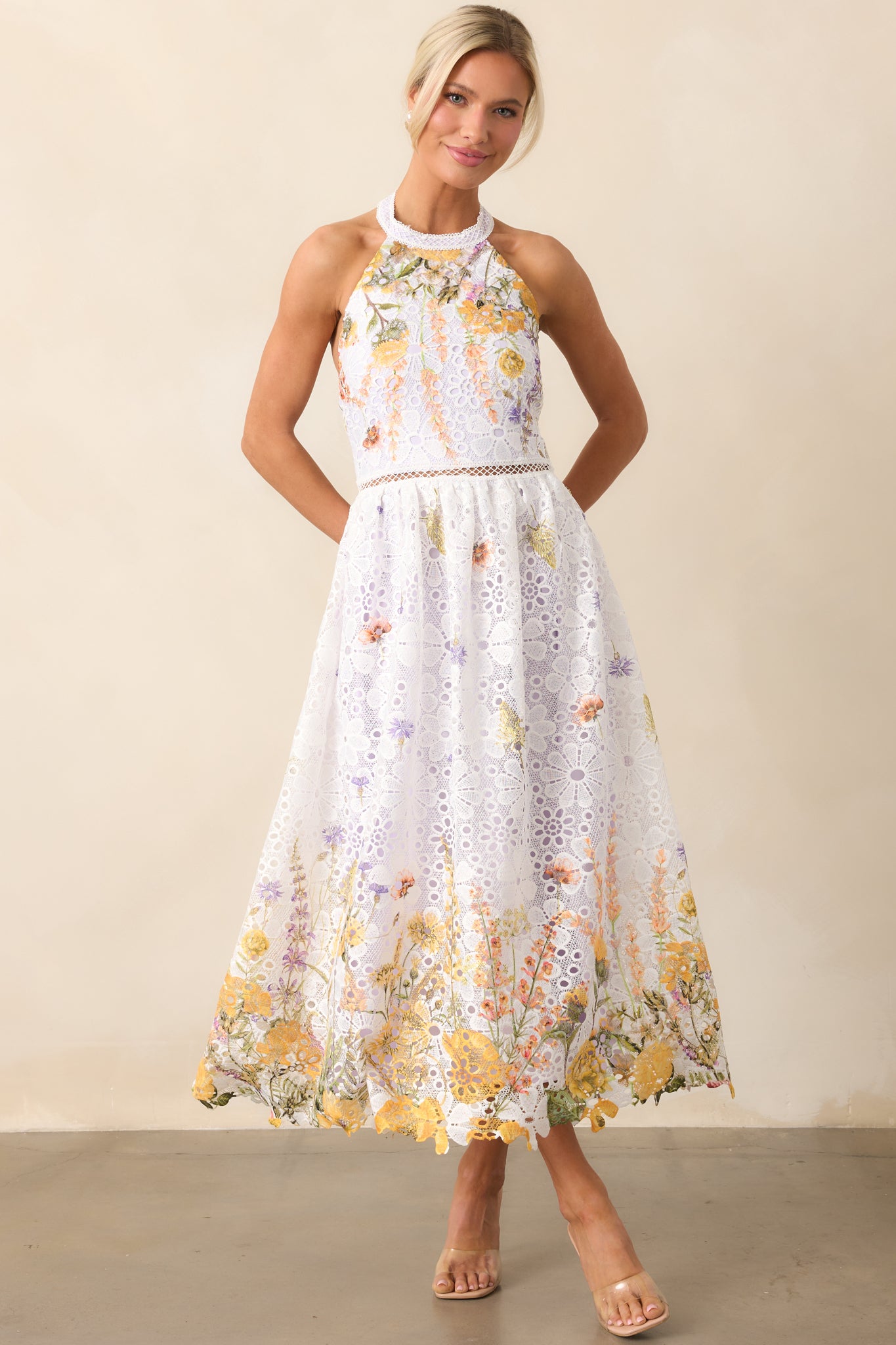 A romantic midi dress with a self-tie halter neckline and intricate open ladder lace detail at the waist.