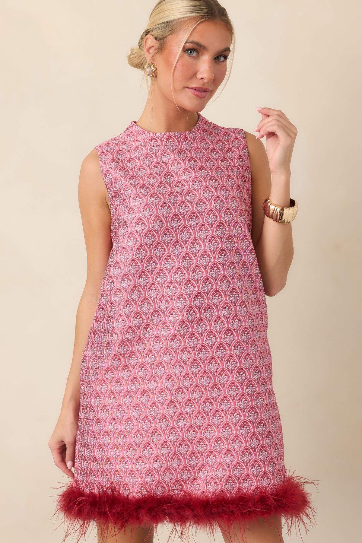 Sleeveless shift mini dress featuring a high round neckline and intricate rose pink and burgundy floral pattern.