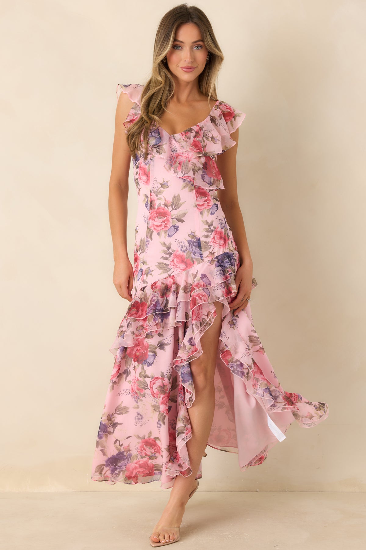 Rose pink floral dress with purple blossoms, muted green leaves, and layered ruffles flowing down the skirt.