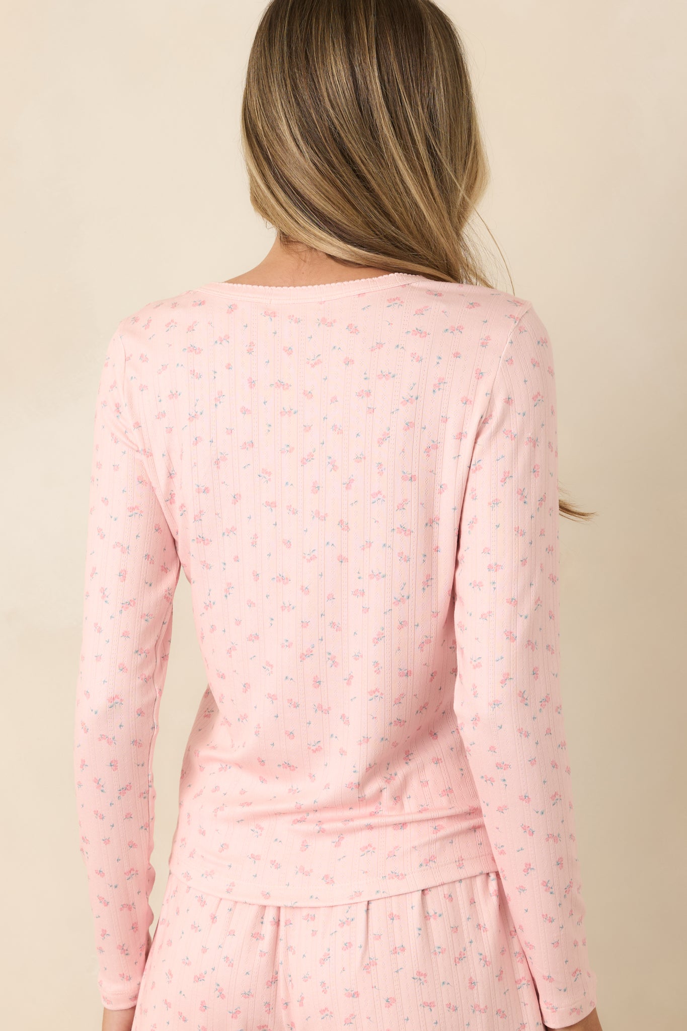 Back view of the rosebud floral pajama top featuring long sleeves, a fitted silhouette, and smooth pointelle fabric.