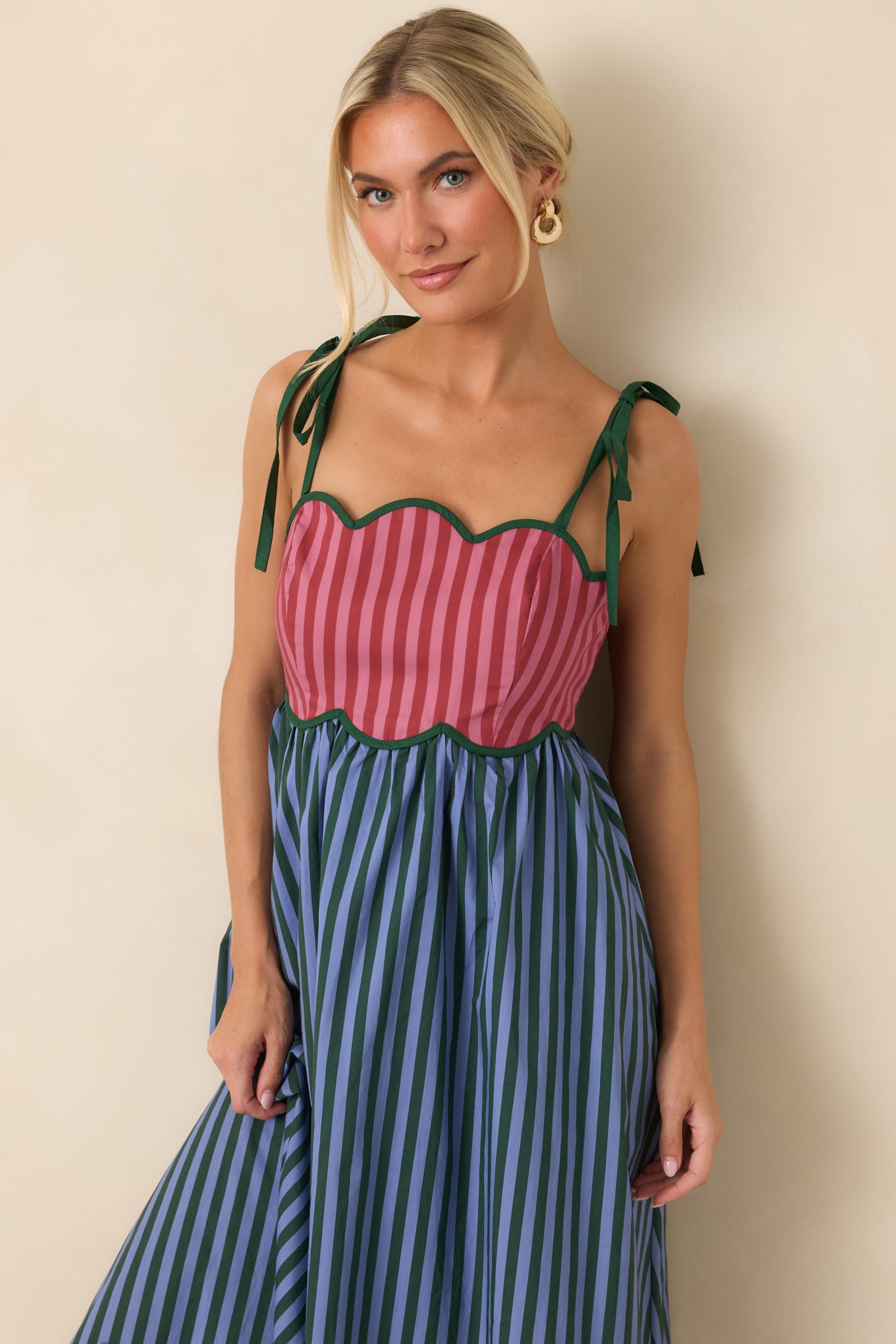 Rosy midi dress featuring a scalloped bodice, blue stripes, hunter green accents, and a full gathered skirt.