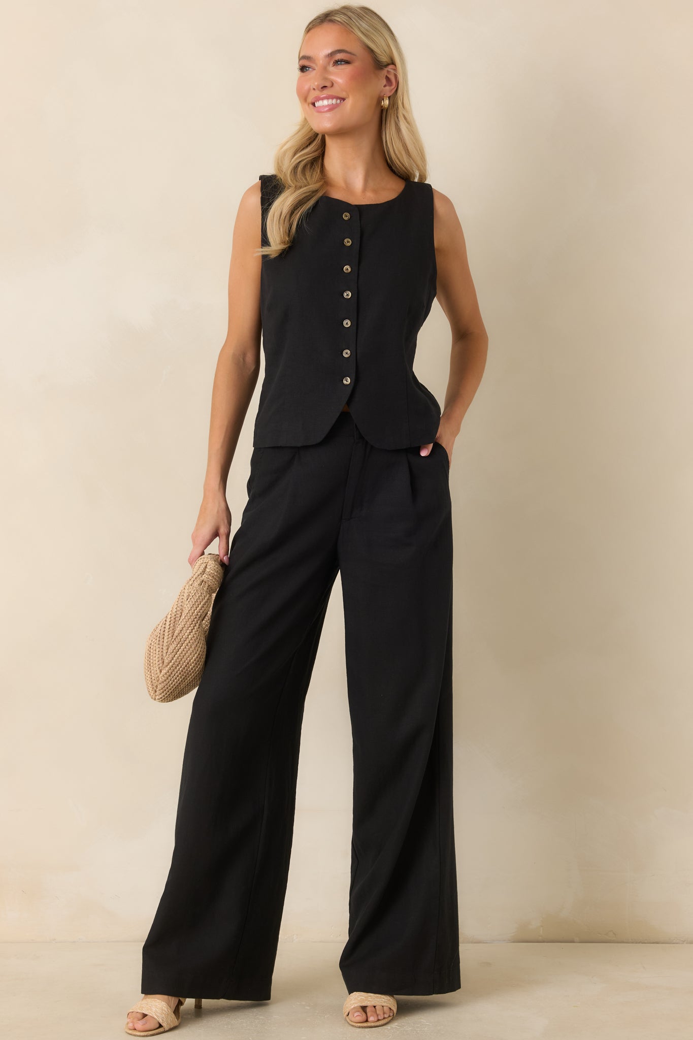 Rounded neckline and tortoise-inspired button front create a timeless look on this lightweight black linen blend vest.