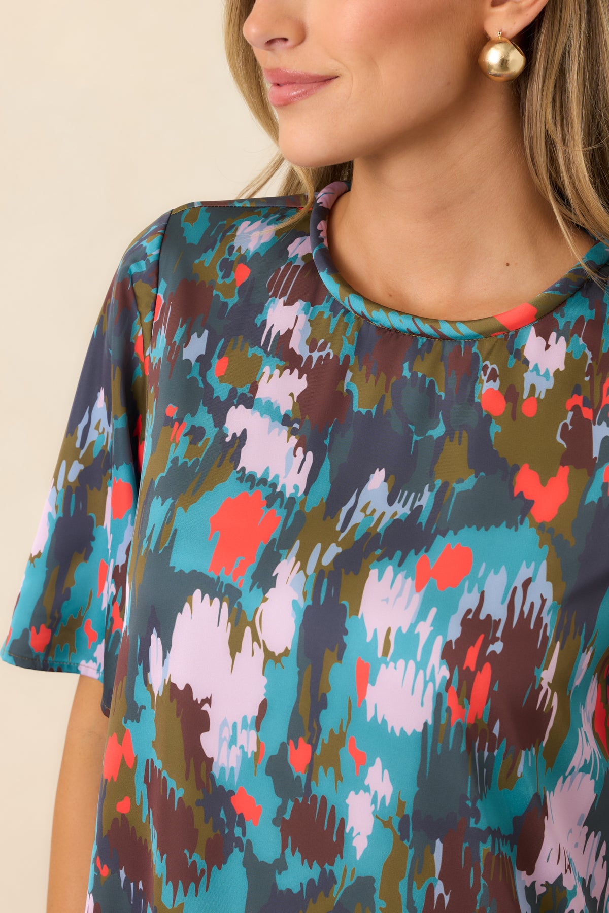 Classic round neckline and loose short sleeves highlight the clean, understated design of the midi dress.