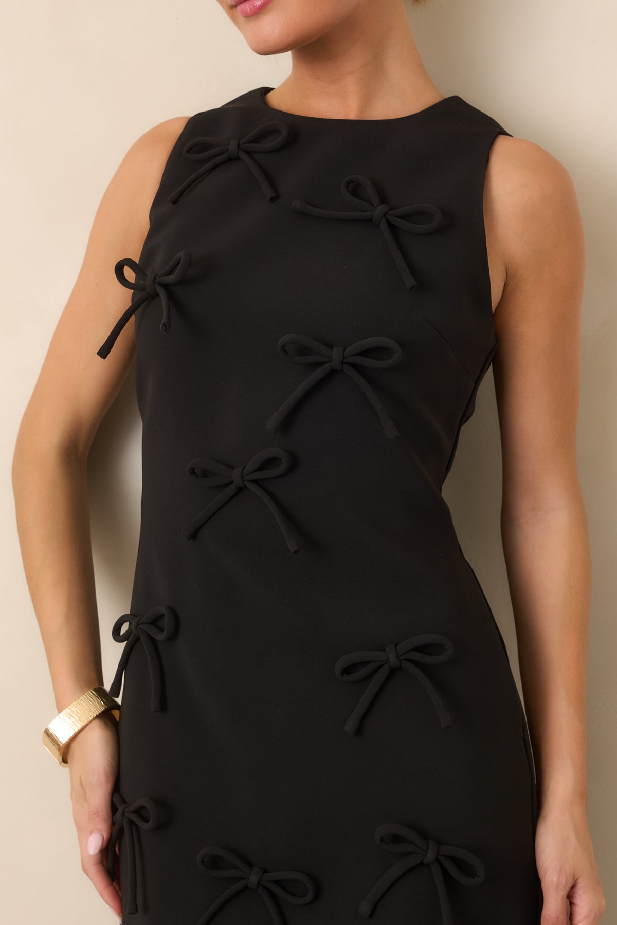 Close-up of the clean round neckline and sculpted seaming across the fitted bodice, showcasing the dress's structured construction.