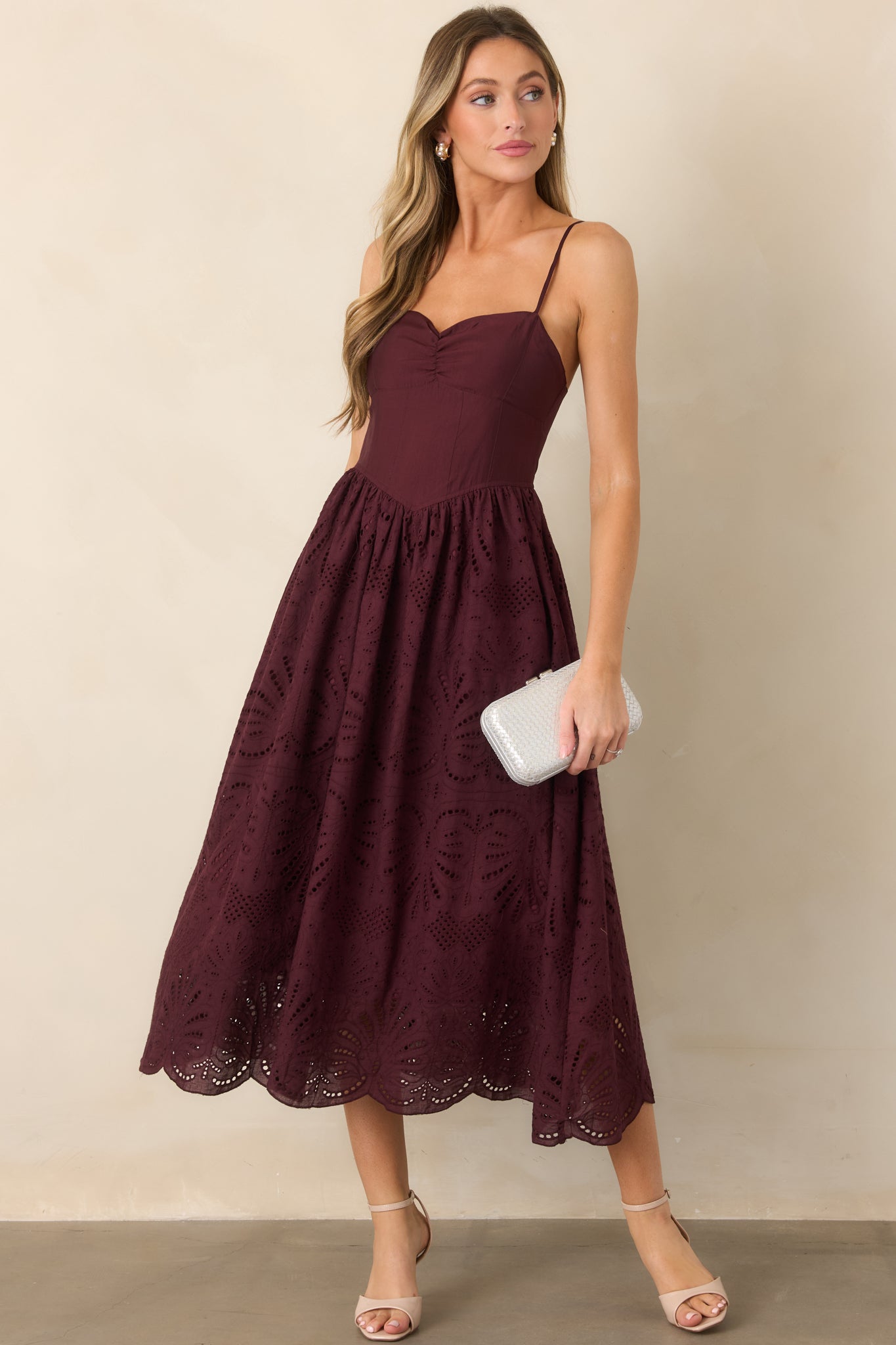 Polished fit-and-flare dress featuring a ruched bust, adjustable shoulder straps, textured eyelet skirt, and gracefully flared silhouette.