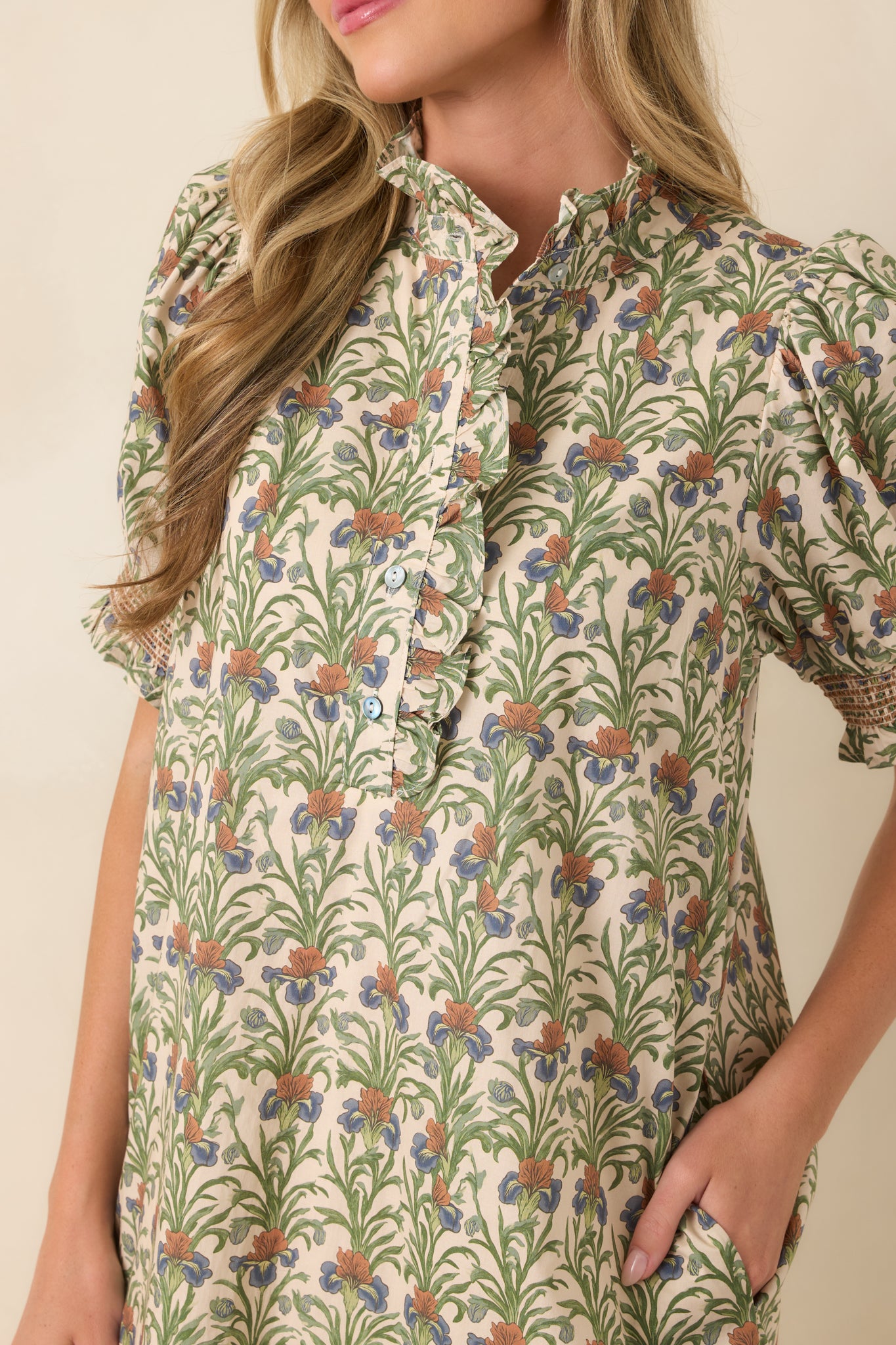 Close-up of the dress highlighting the ruffled stand collar, partial button front, and intricate botanical print details.