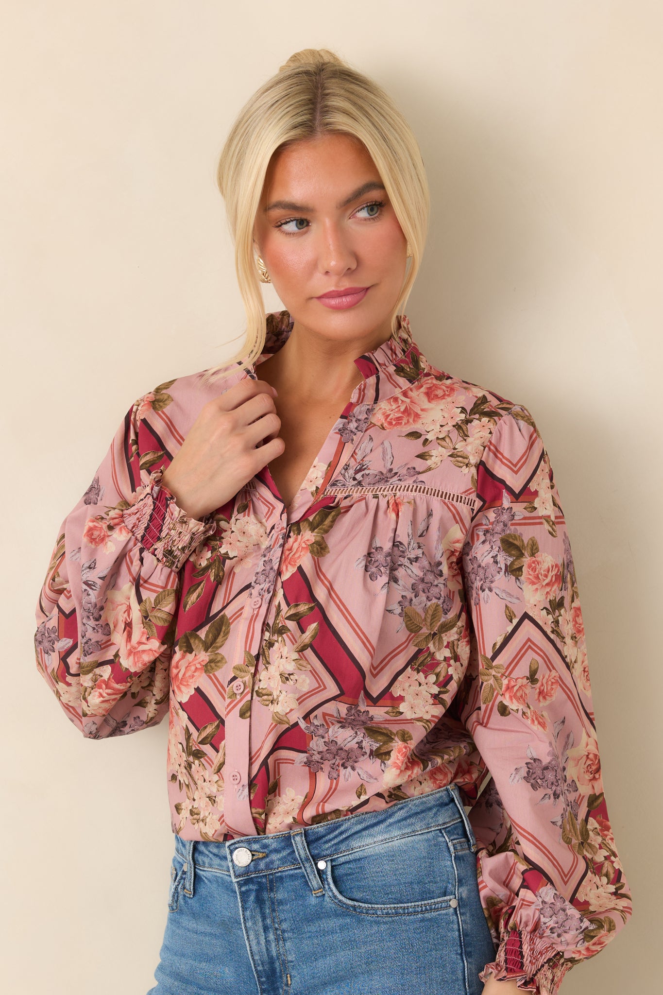 Front detail of the cotton top highlighting the ruffled stand collar, button-front closure, and gathered yoke.