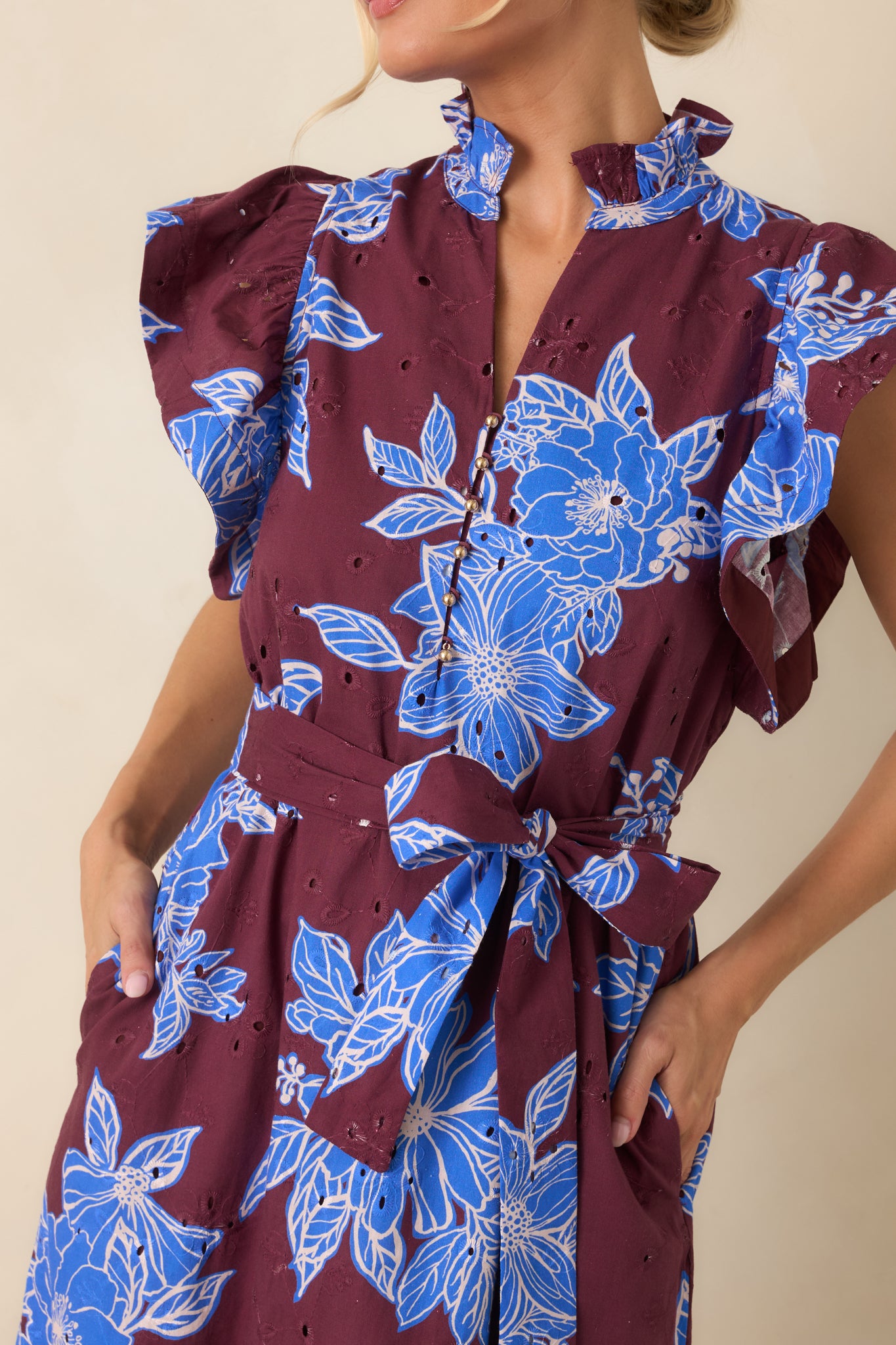 Detailed view of the dress highlighting the ruffled mock neckline, gold button accents, and soft cotton fabric.