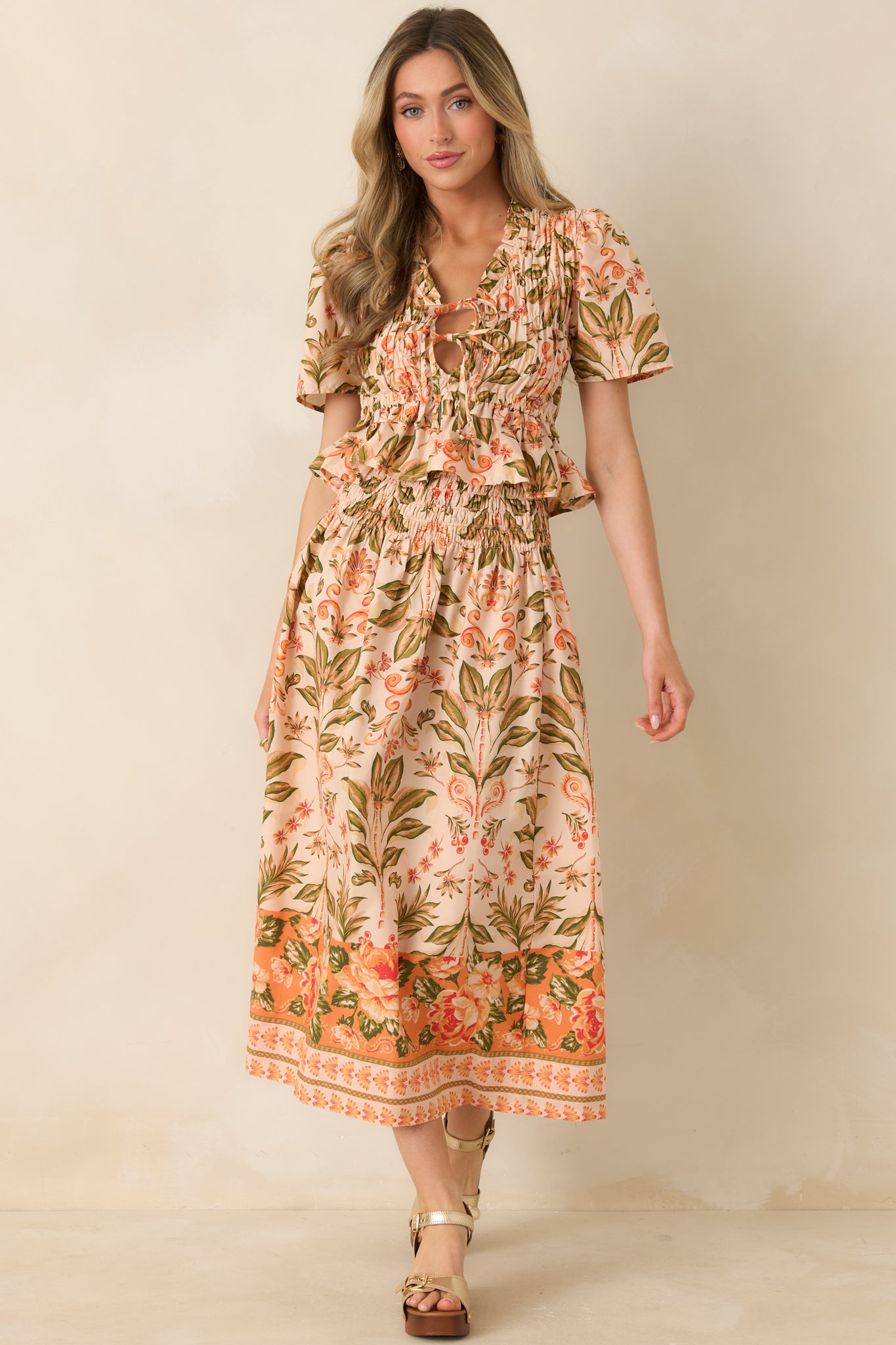 Ruffled V-neck top with adjustable front ties and gathered short sleeves.