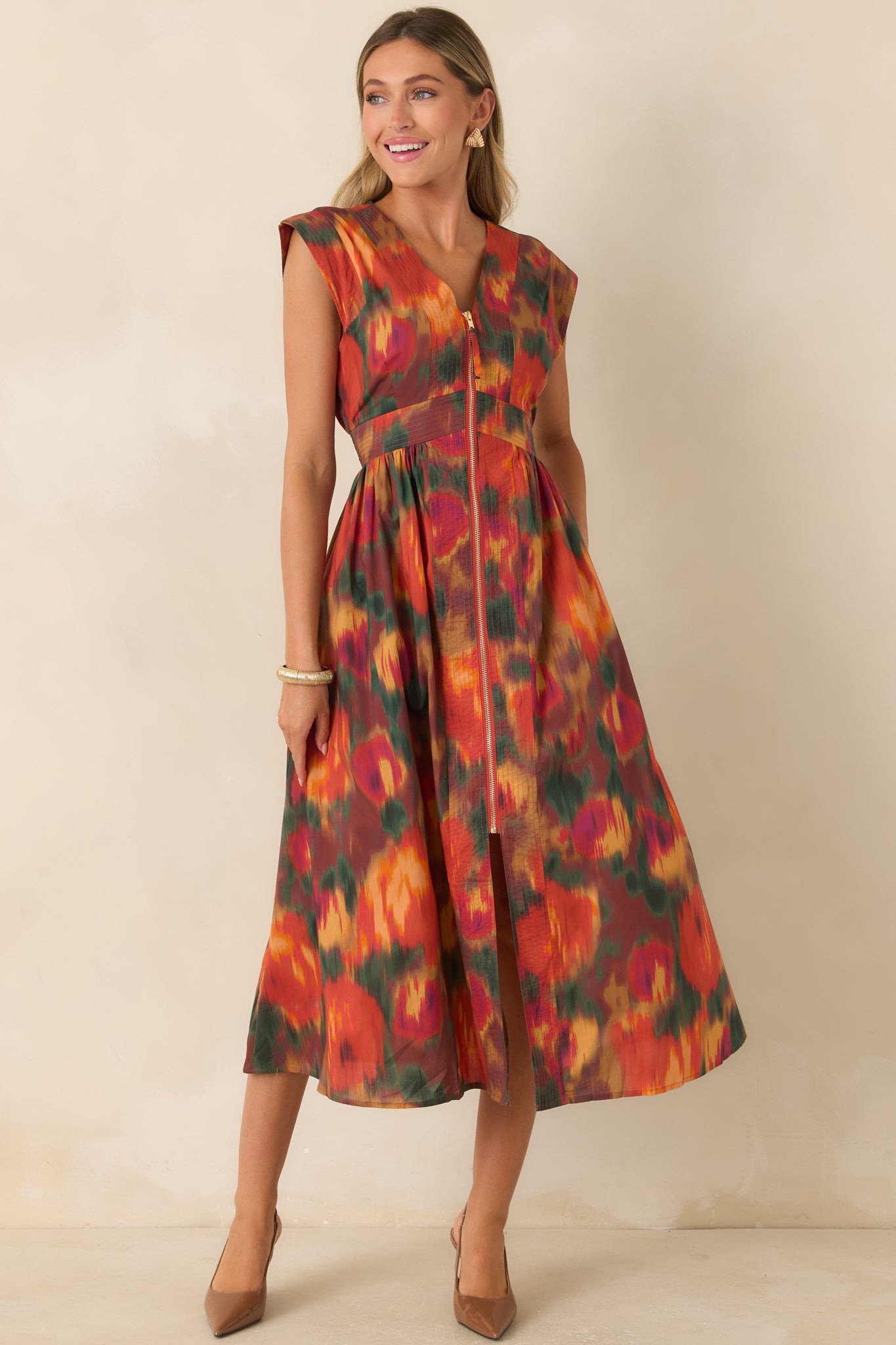 Rust floral midi dress featuring a painterly multicolor print, V-neckline, structured cap sleeves, defined waist, and gathered full skirt.