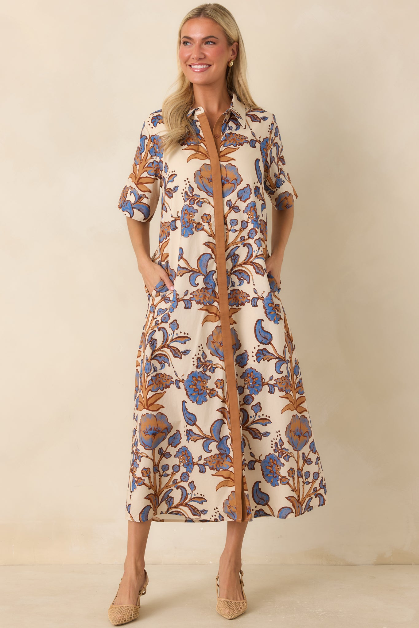 Printed cotton dress with warm rust and tan floral details, functional buttons, and a comfortable lined finish.
