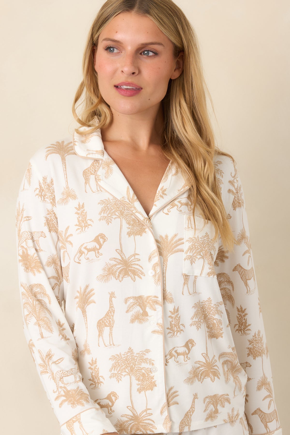Button-front detailing runs through the scenic safari print, with a chest pocket adding a practical accent to the top.