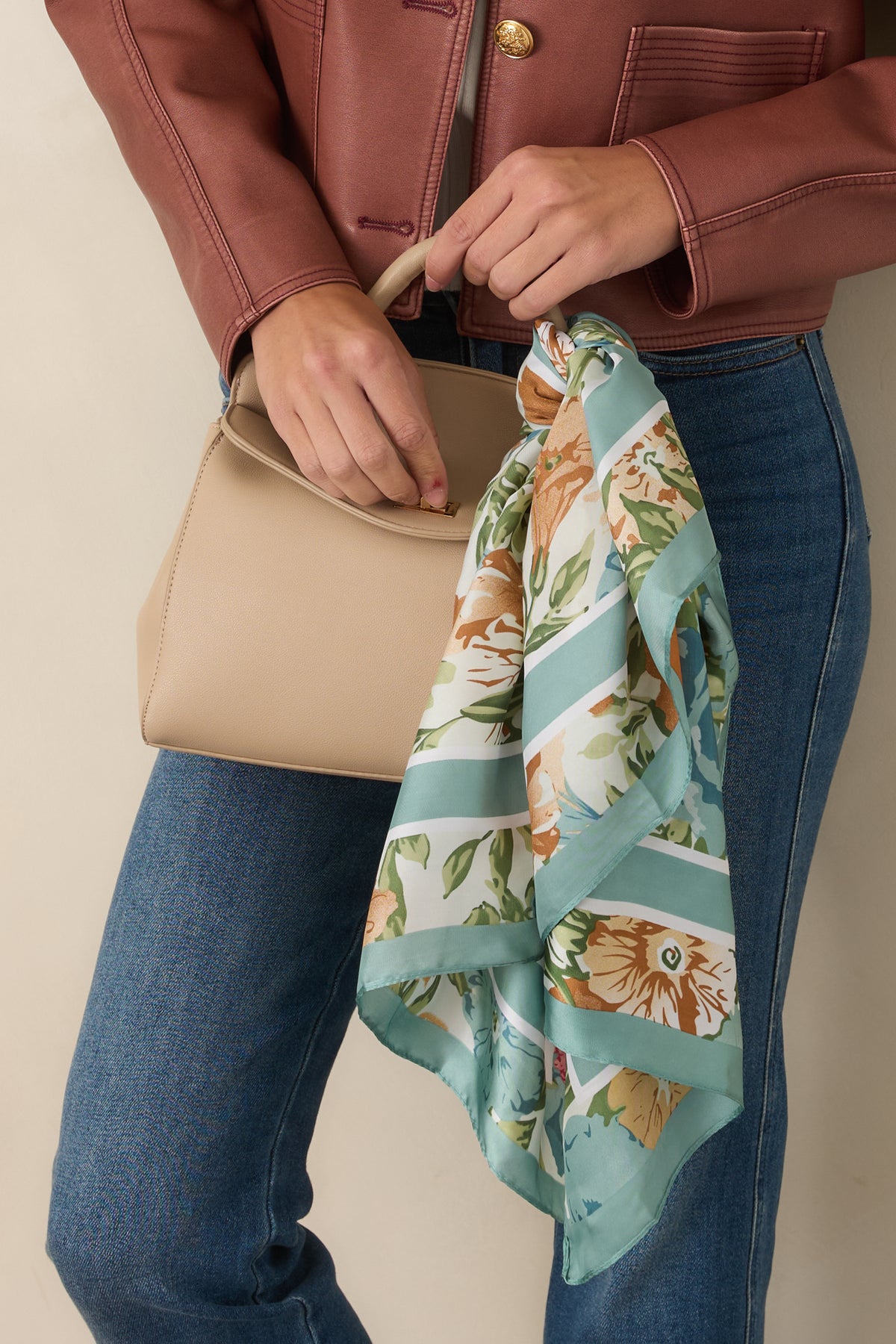 Sage blue scarf showcasing painterly floral blooms in ivory, camel, leafy green, and bright pink accents.