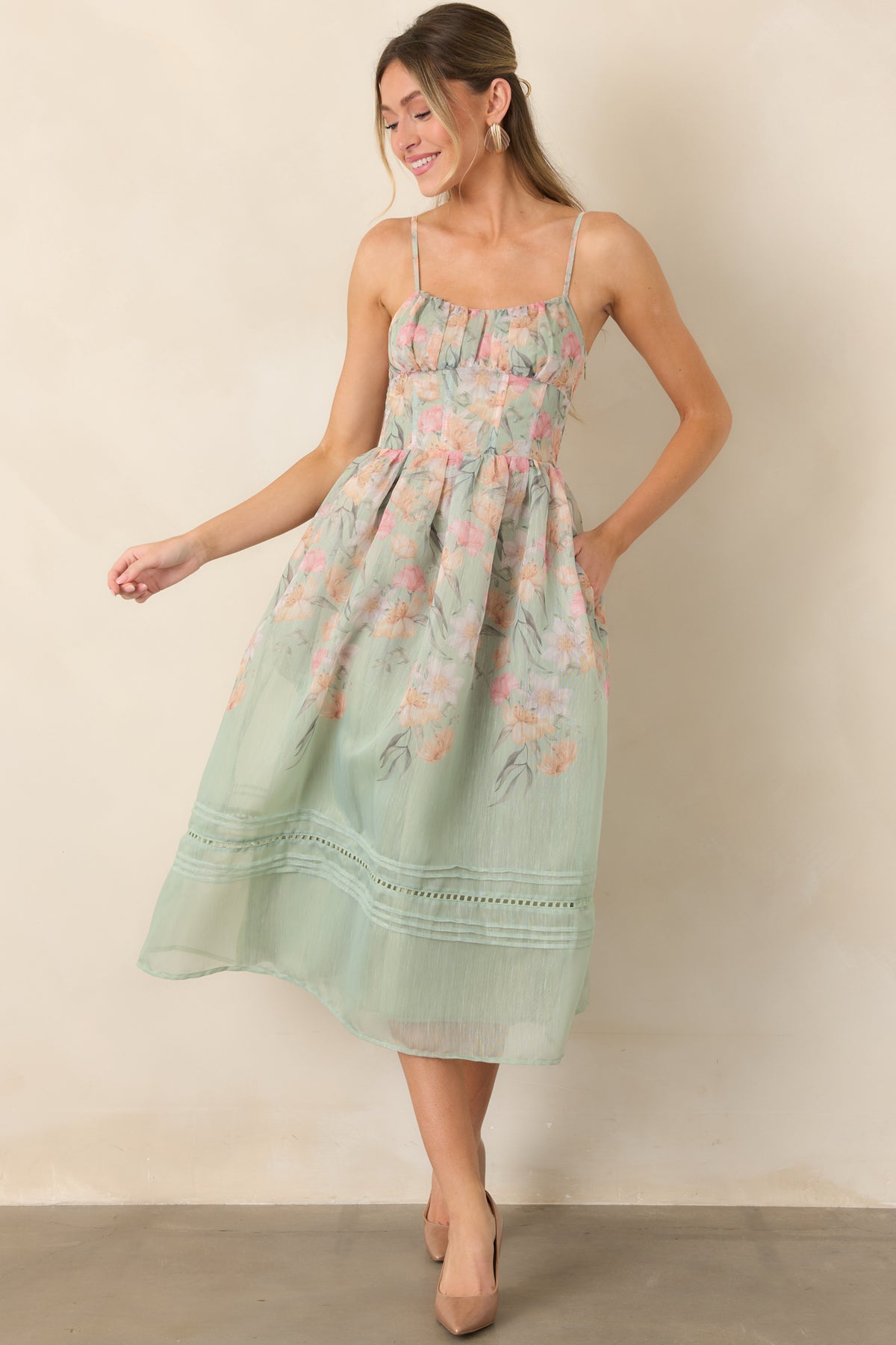 Sage floral dress with a fitted bodice flowing into a full A-line skirt.