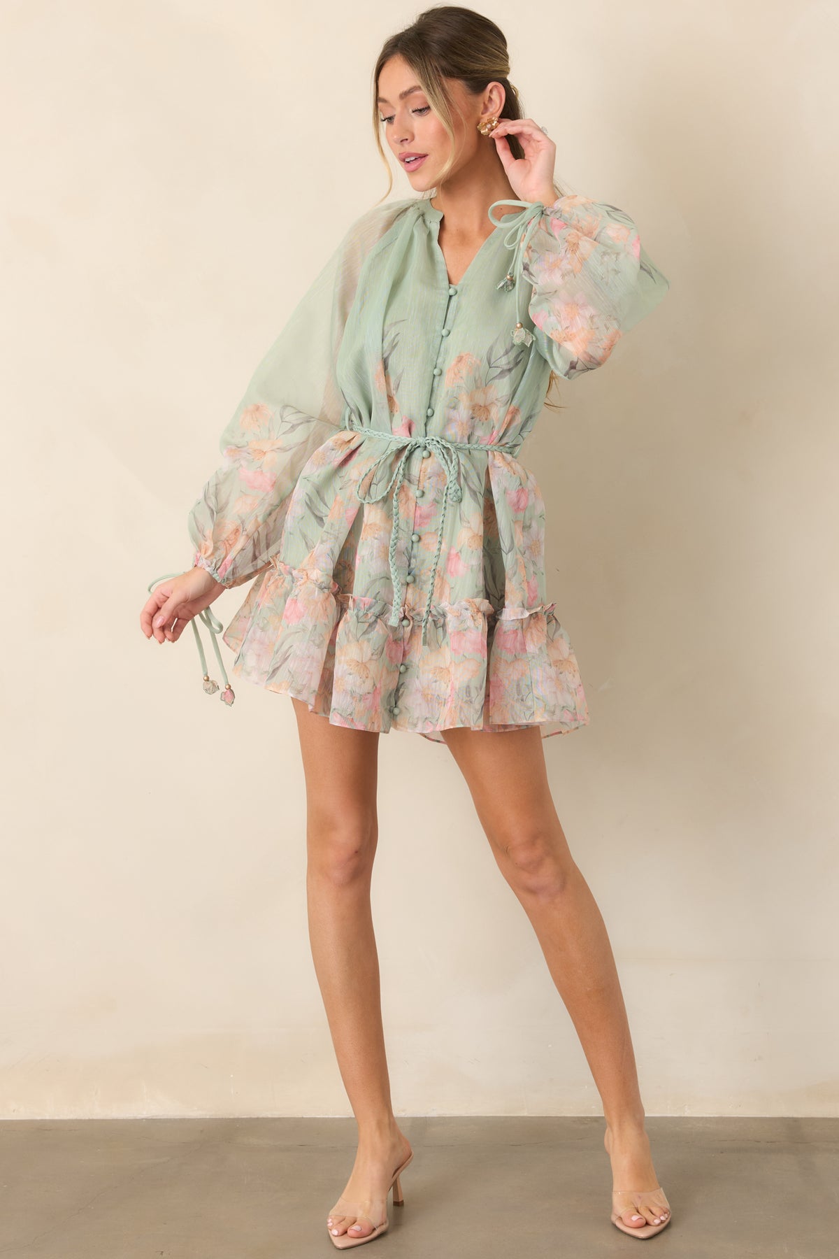 Sage green dress with a defined waist and playful tiered ruffle hem.