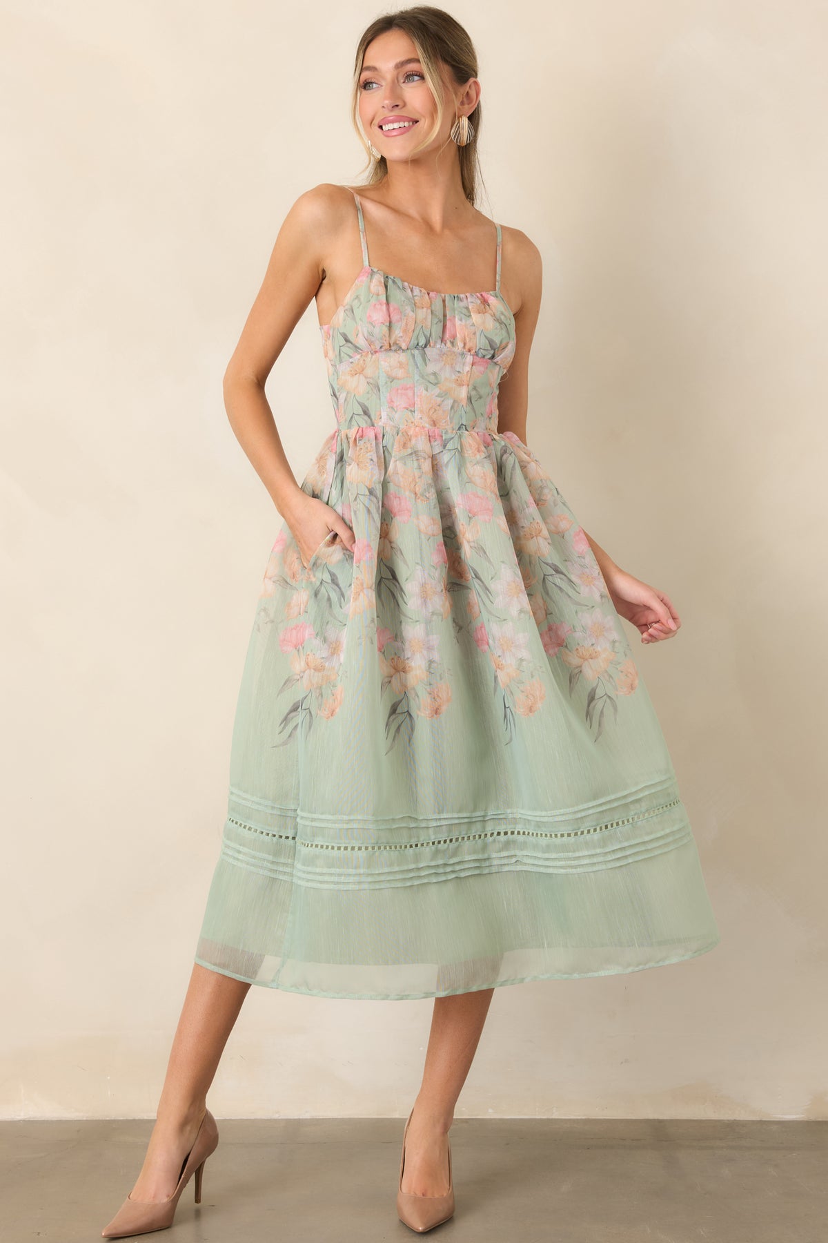 Sage green dress showcasing a flexible bodice and flowing A-line silhouette.
