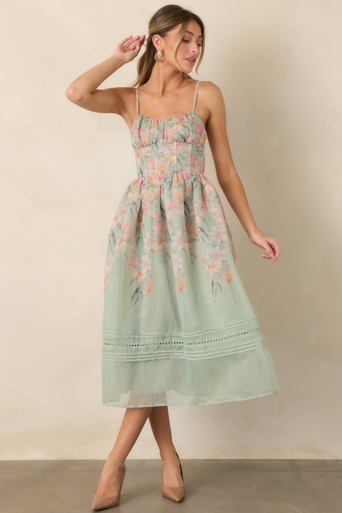 Sage green floral dress featuring a softly ruched bust and fitted seamed bodice.