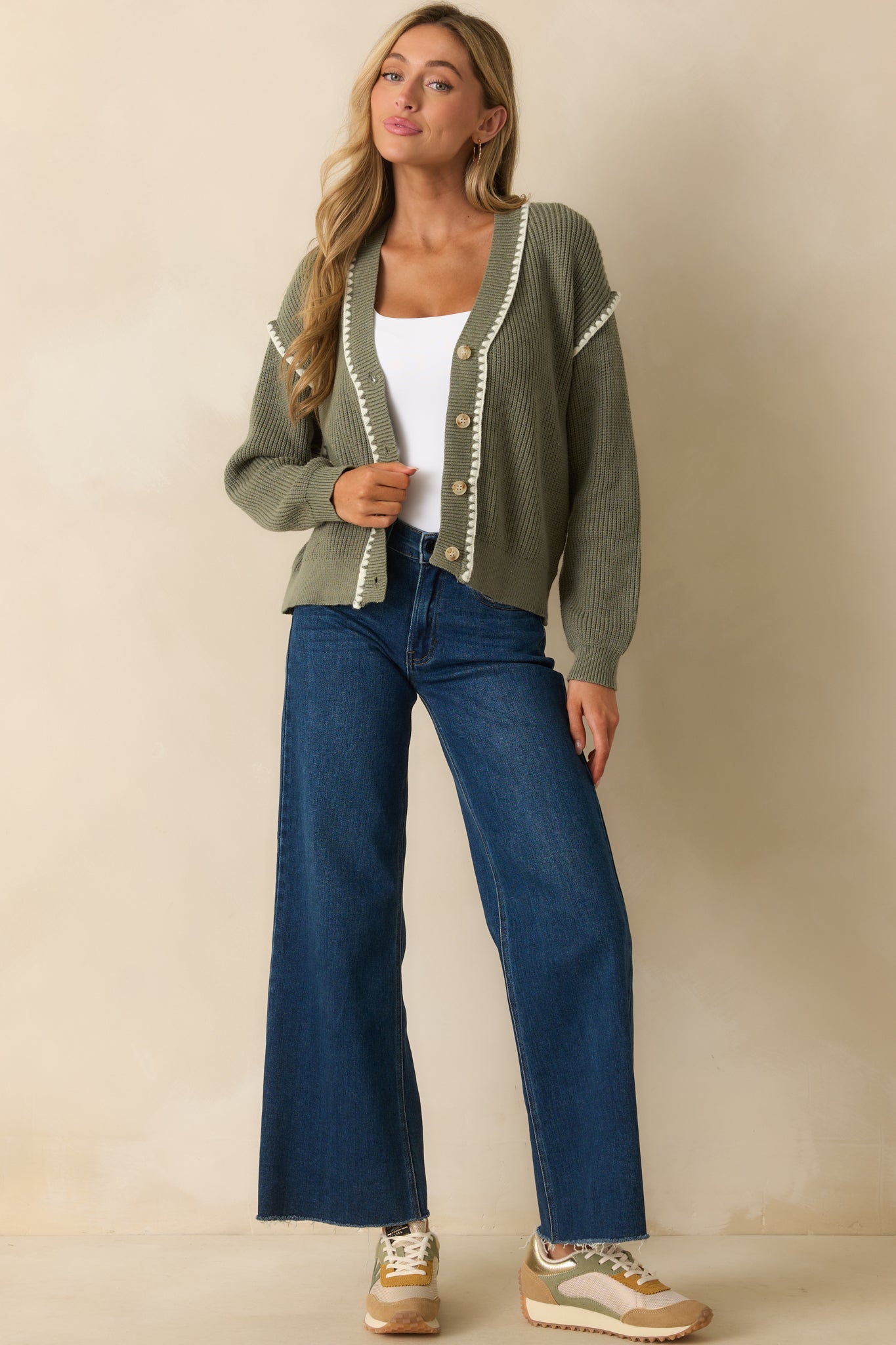 Sage green ribbed knit cardigan with long sleeves, v-neckline, and functional button front.