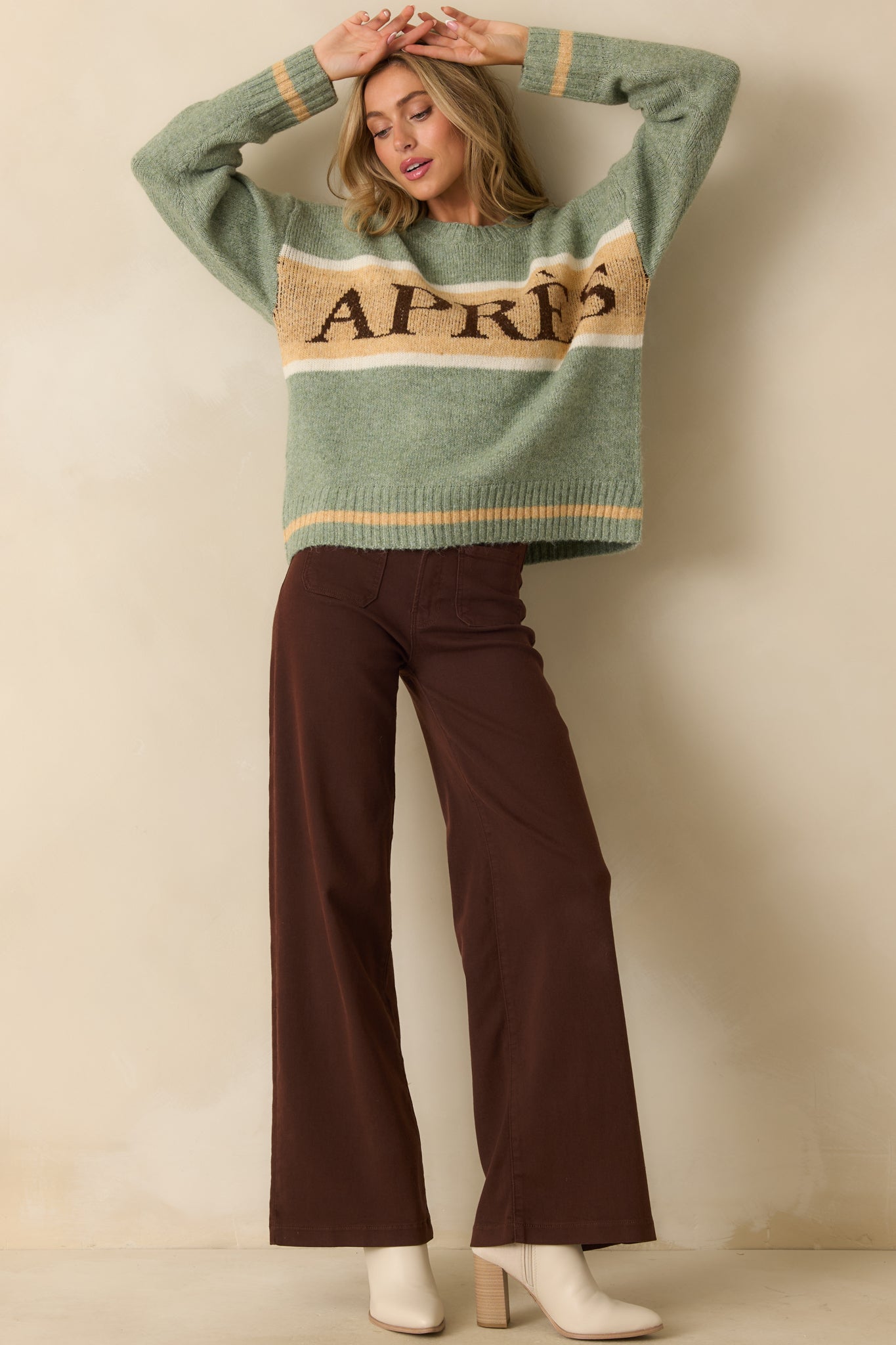 Sage green sweater emphasizing the ribbed cuffs, hem, and casual, laid-back style.