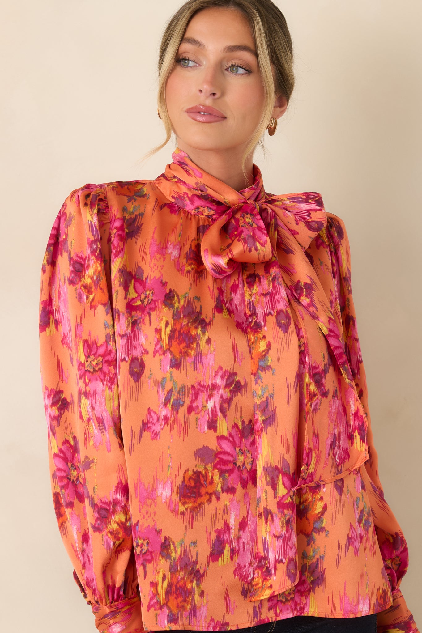 Upper portion of the blouse showcasing the statement neck tie, smooth satin finish, and voluminous balloon sleeves.