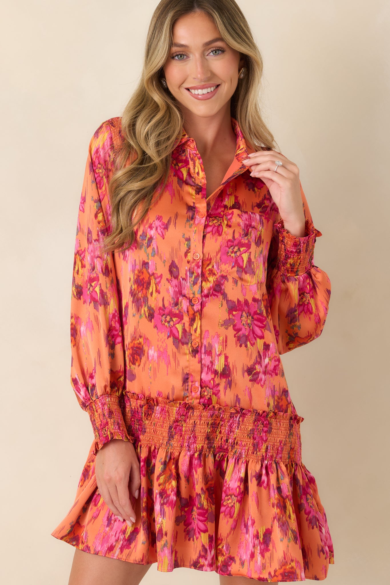 Front detail of the satin mini dress highlighting the collared neckline, button-front closure, and smooth softly reflective fabric.