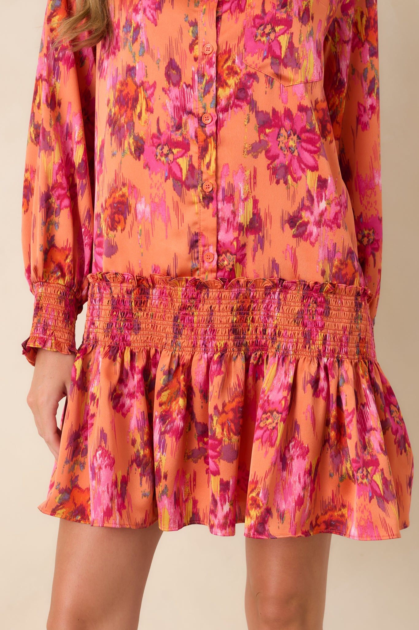 Lower detail of the mini dress showcasing the flowing flouncy skirt and smooth polyester satin construction.