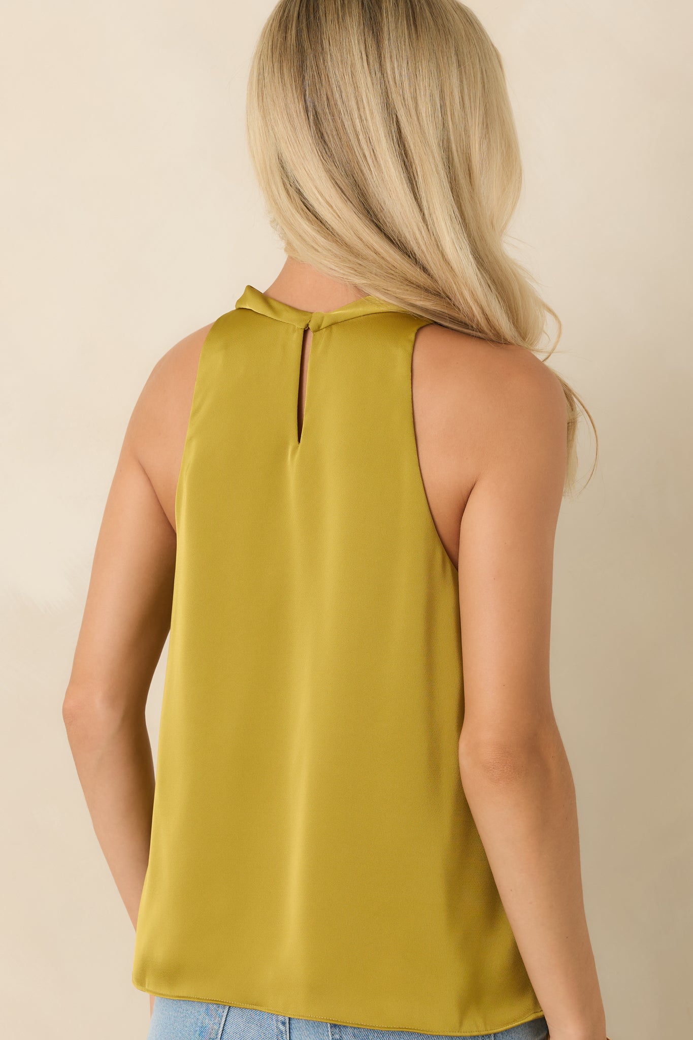 Back of the satin-look top featuring a keyhole closure with a single button detail.