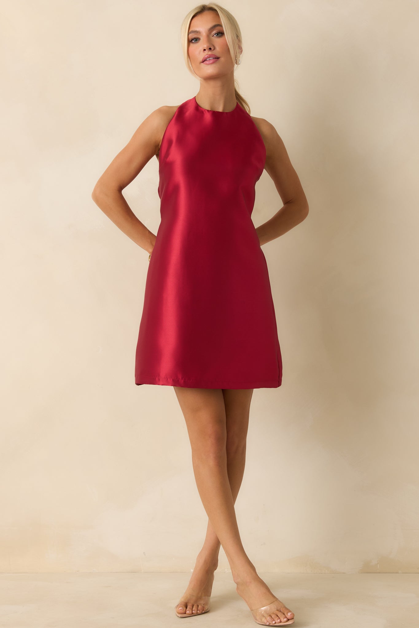 Satin mini dress in bright red with a structured halter neckline and elegant drape.