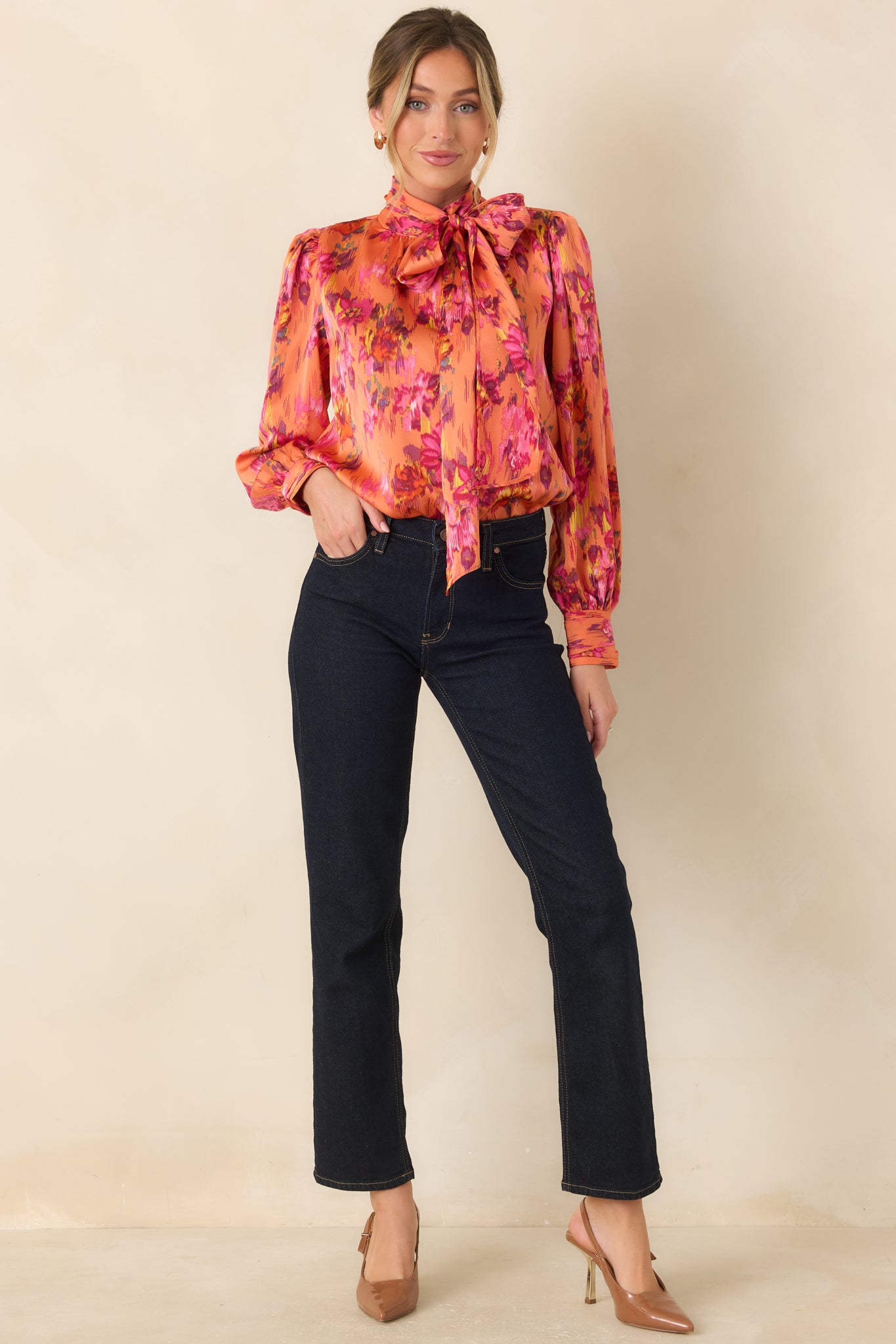 Silky polyester satin top featuring a dramatic tie neckline, lightly gathered shoulders, long balloon sleeves, and buttoned cuffs with a softly polished sheen.
