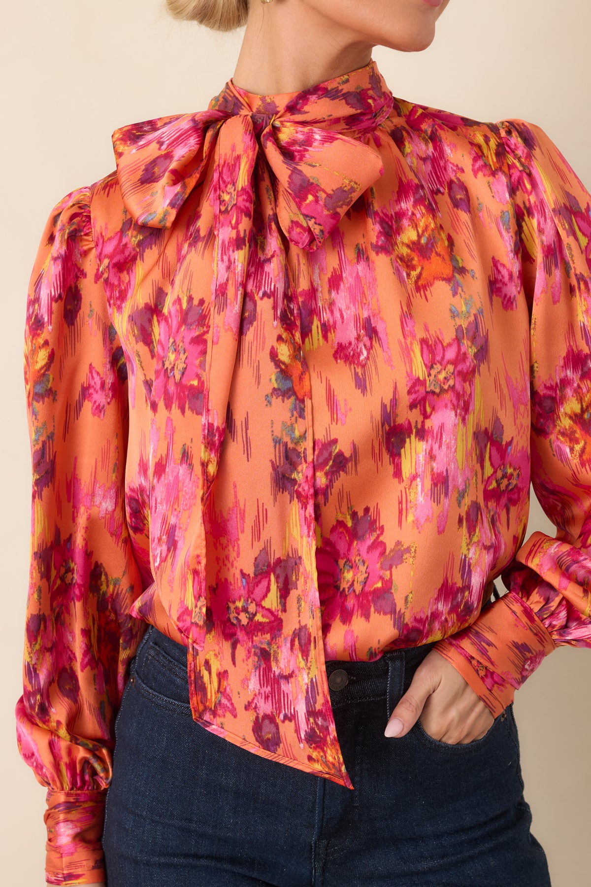 Close-up of the satin top highlighting the dramatic tie neckline, gathered shoulder detail, and soft sheen of the polyester fabric.