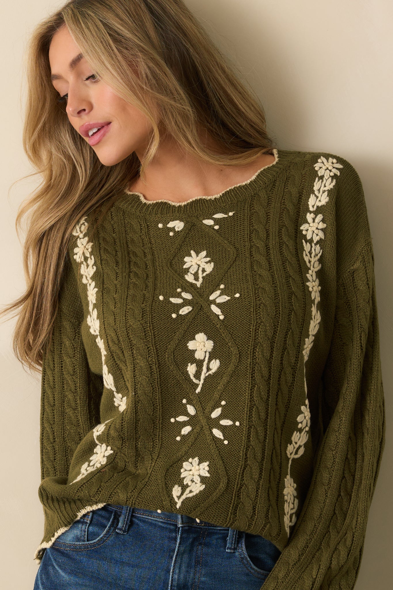 Scalloped knit hemline paired with textured cable knit design.