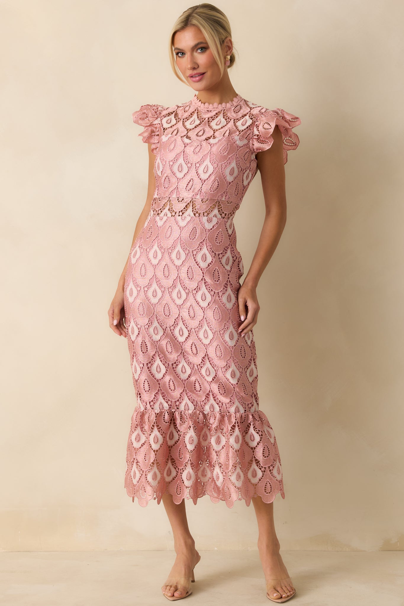 The dress highlights scalloped lace edges and sheer lace insets along the skirt and bodice.