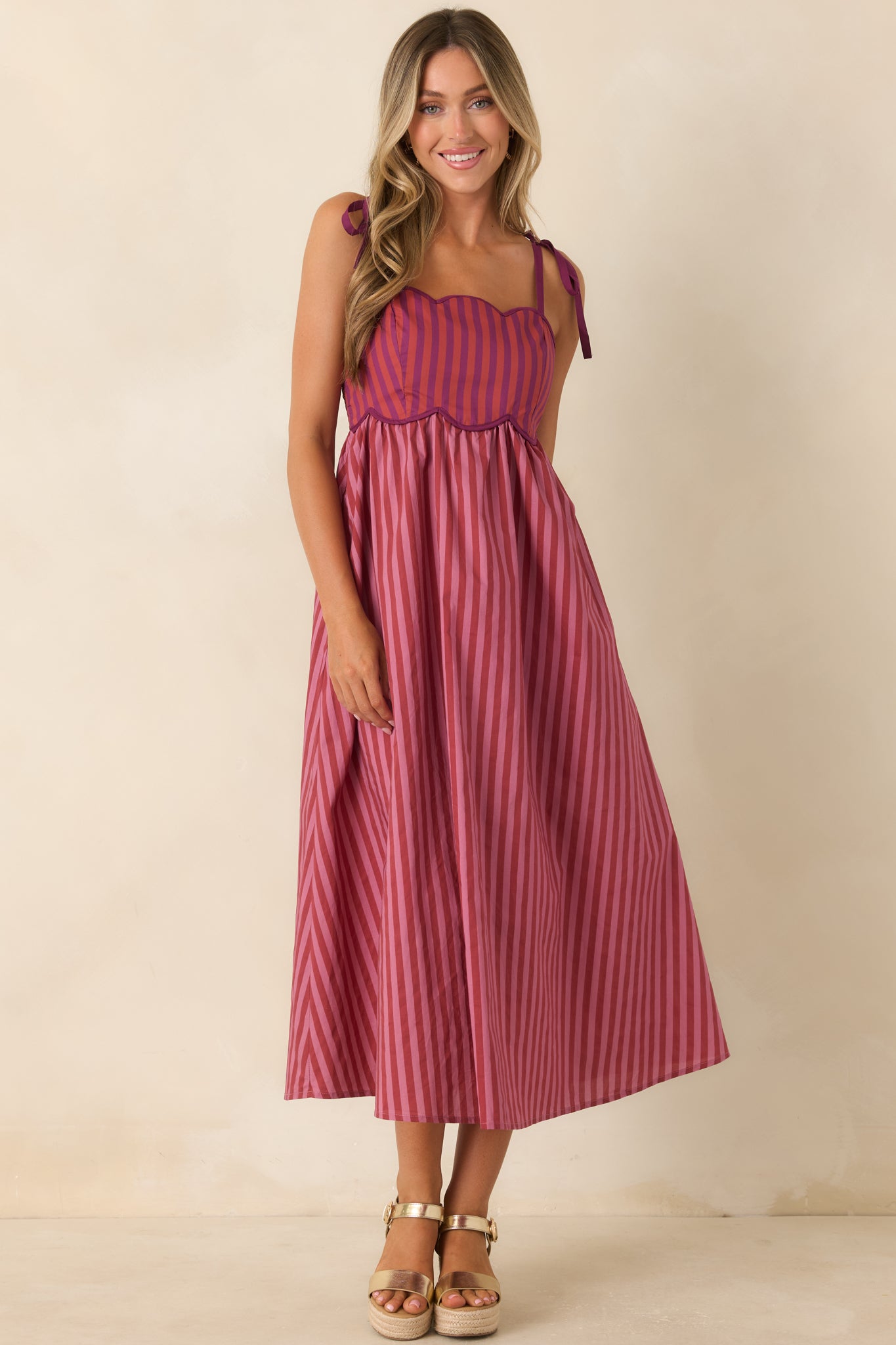 Statement striped dress featuring a scalloped neckline, smocked back, and comfortable relaxed fit.