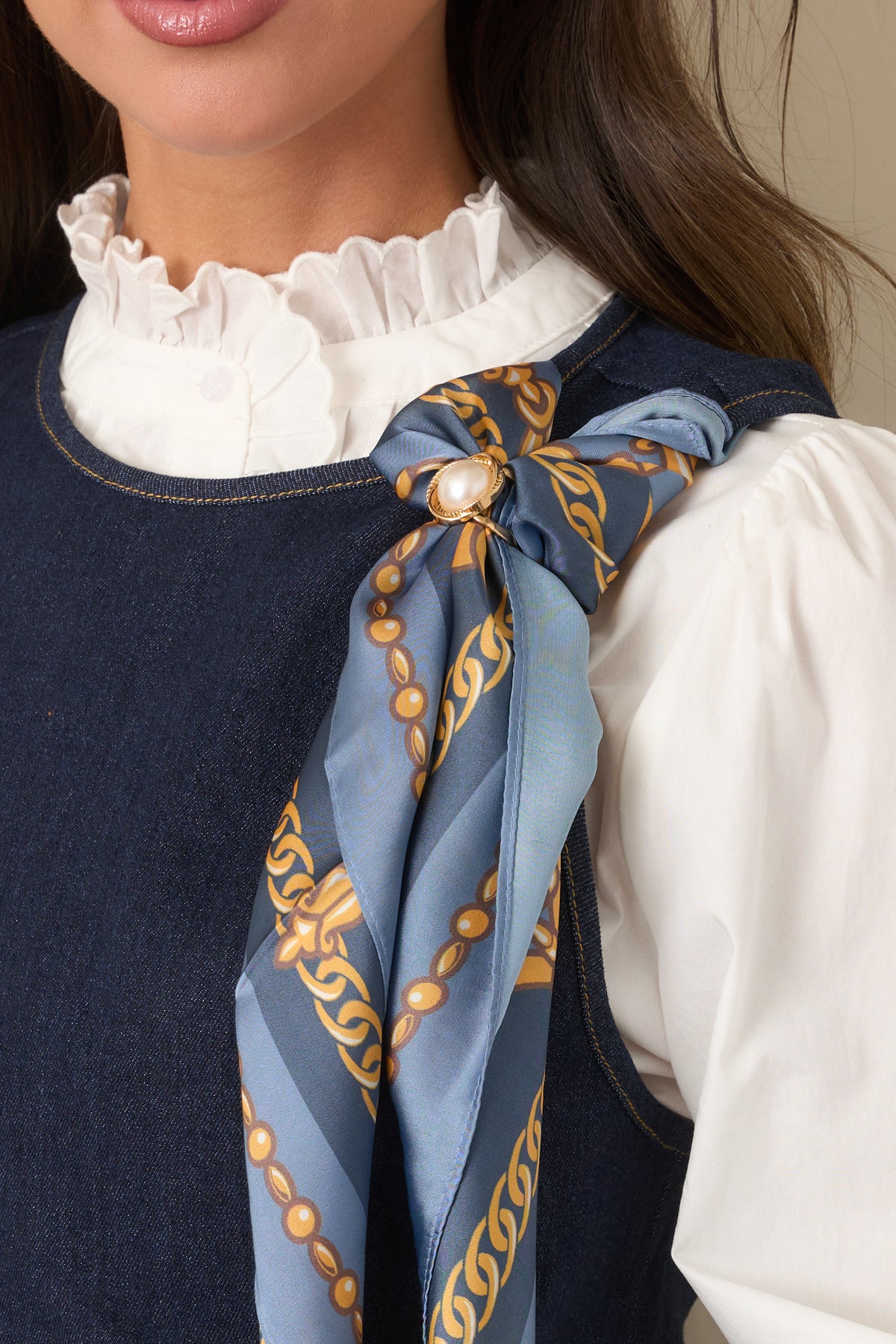 Scarf highlighting the ornate gold chain motifs and decorative medallion print.