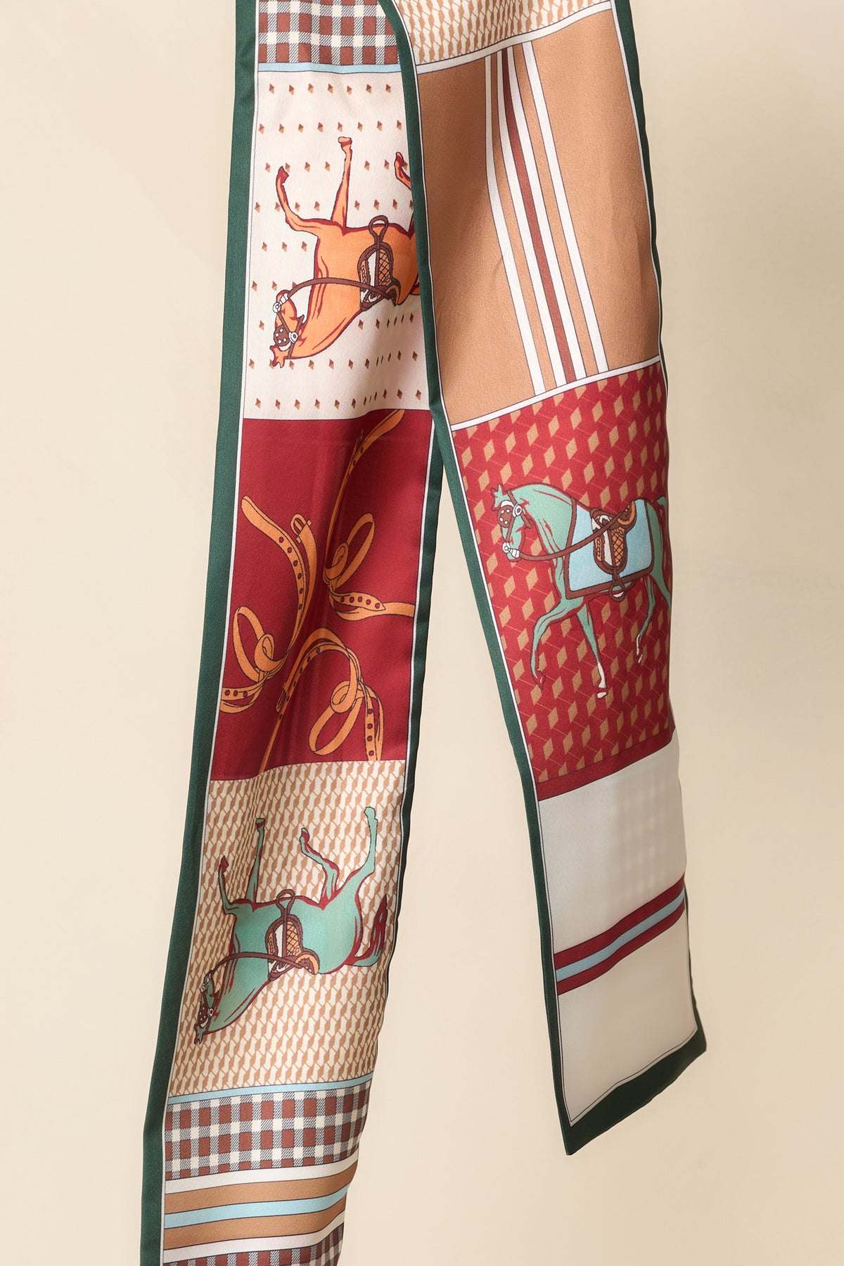 Close-up of the scarf’s horse motifs, geometric patterning, and contrasting forest green trim.