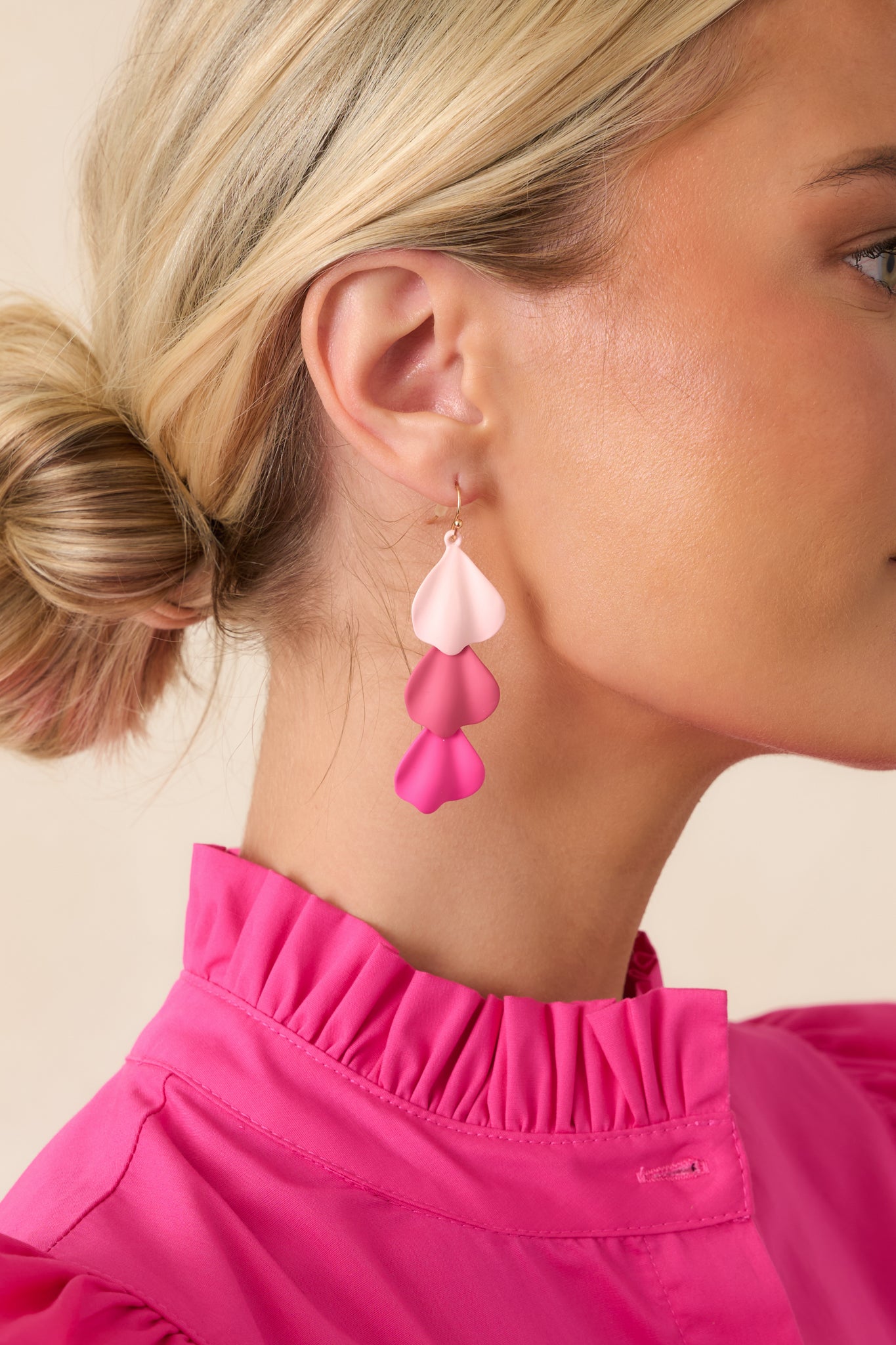 Sculptural earrings showcasing flowing shapes that create a soft petal-like effect.