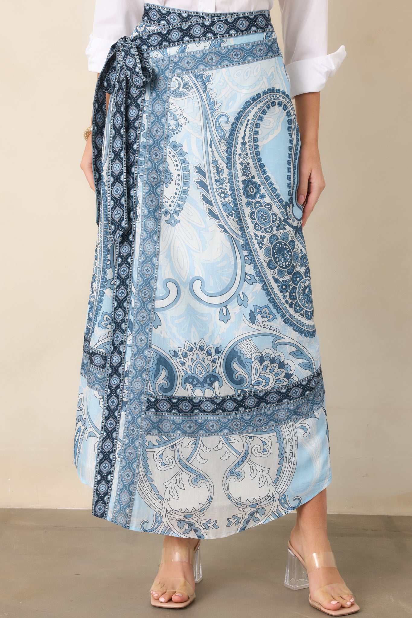 Self-tie waist and overlapping wrap panels define the polished construction of this flowing maxi skirt.