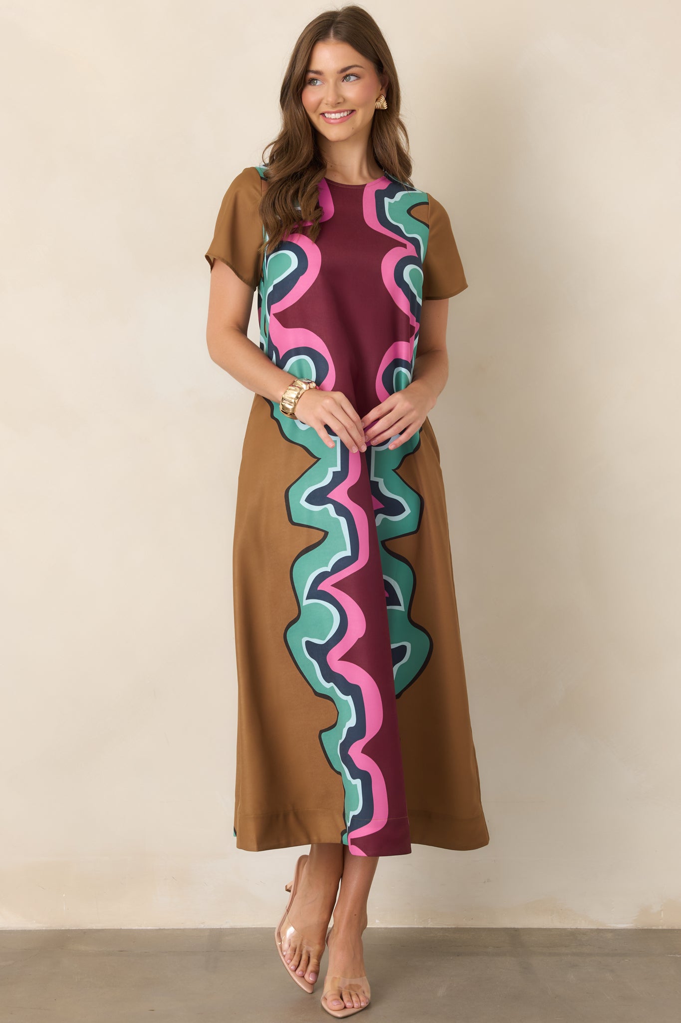 Serpentine-print maxi dress featuring a round neckline, short sleeves, relaxed silhouette, and multicolored burgundy, camel, seafoam green, navy, light blue, and pink pattern.