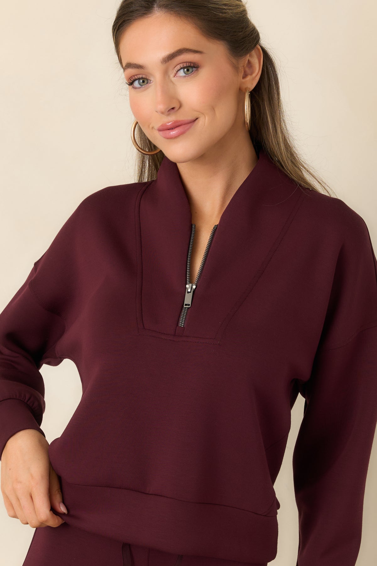 Shawl collar framing the half-zip neckline of the soft pullover.