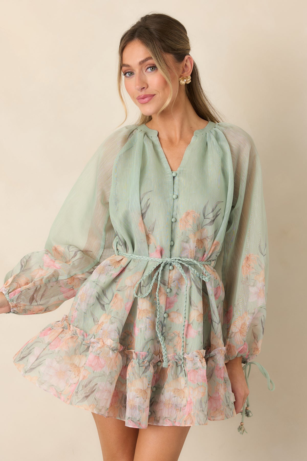 Sheer balloon sleeves with floral-accented tie cuffs enhance this floral mini dress.