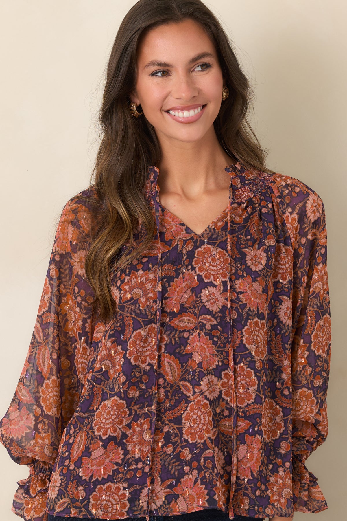 Long sheer sleeves with a colorful floral pattern and softly gathered ruffled cuffs.