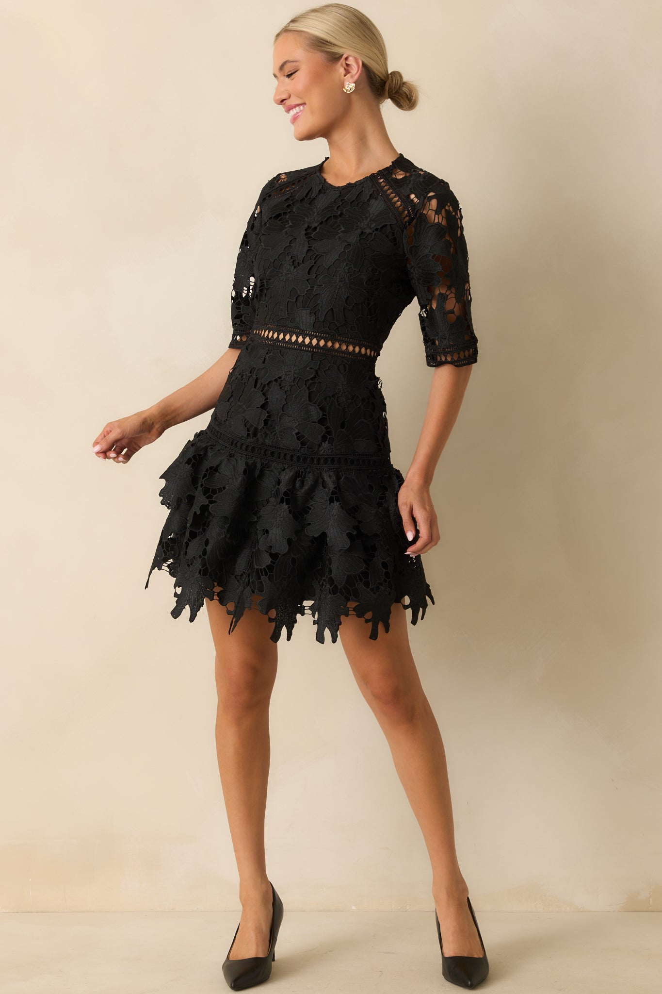 Sheer lace cutouts highlight the bodice and waistline, balancing the fitted silhouette.