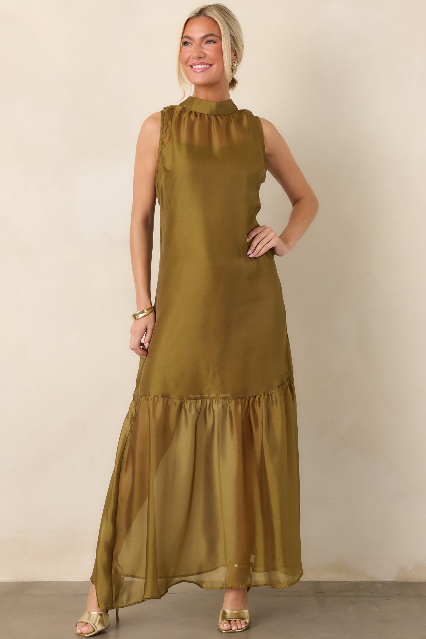 Sheer organza dress with an airy maxi-length silhouette, polished high neckline, softly gathered skirt, and visible mini-length lining underneath.