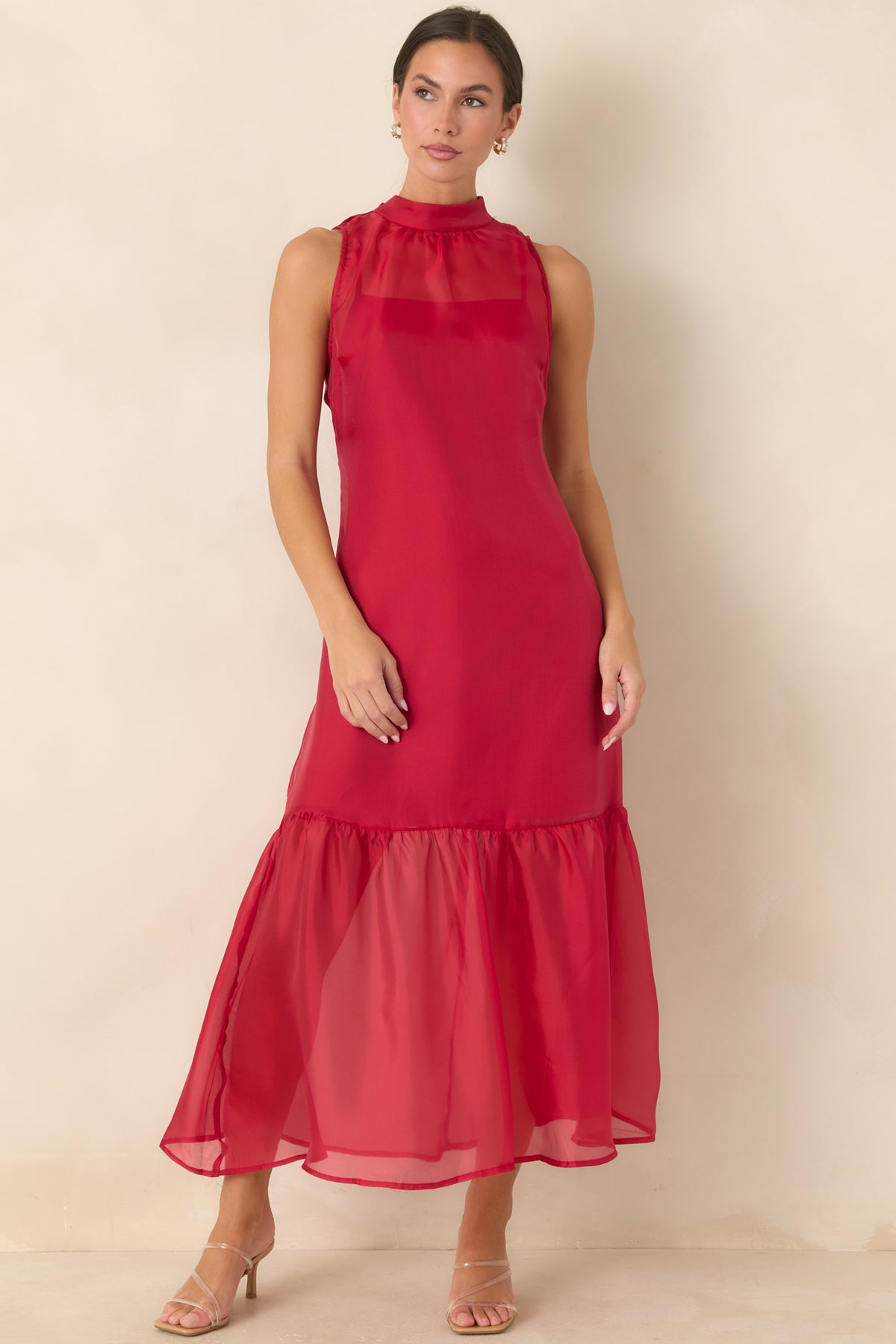 Long sheer organza dress with a high neckline and mini-length slip lining beneath the skirt.
