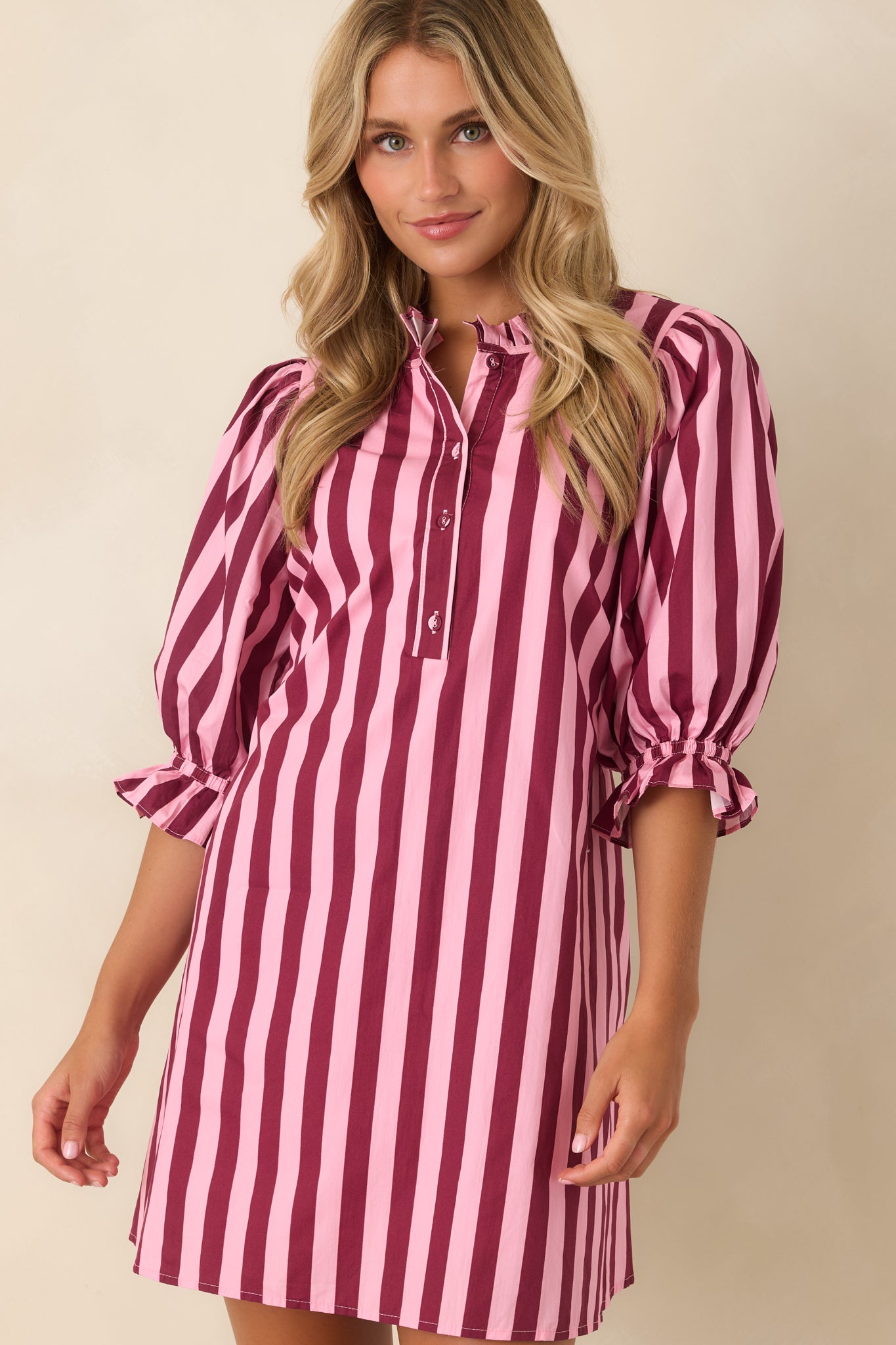Shift mini dress showcasing the button-front placket, textured stripes, ruffled neckline, and soft cotton construction.