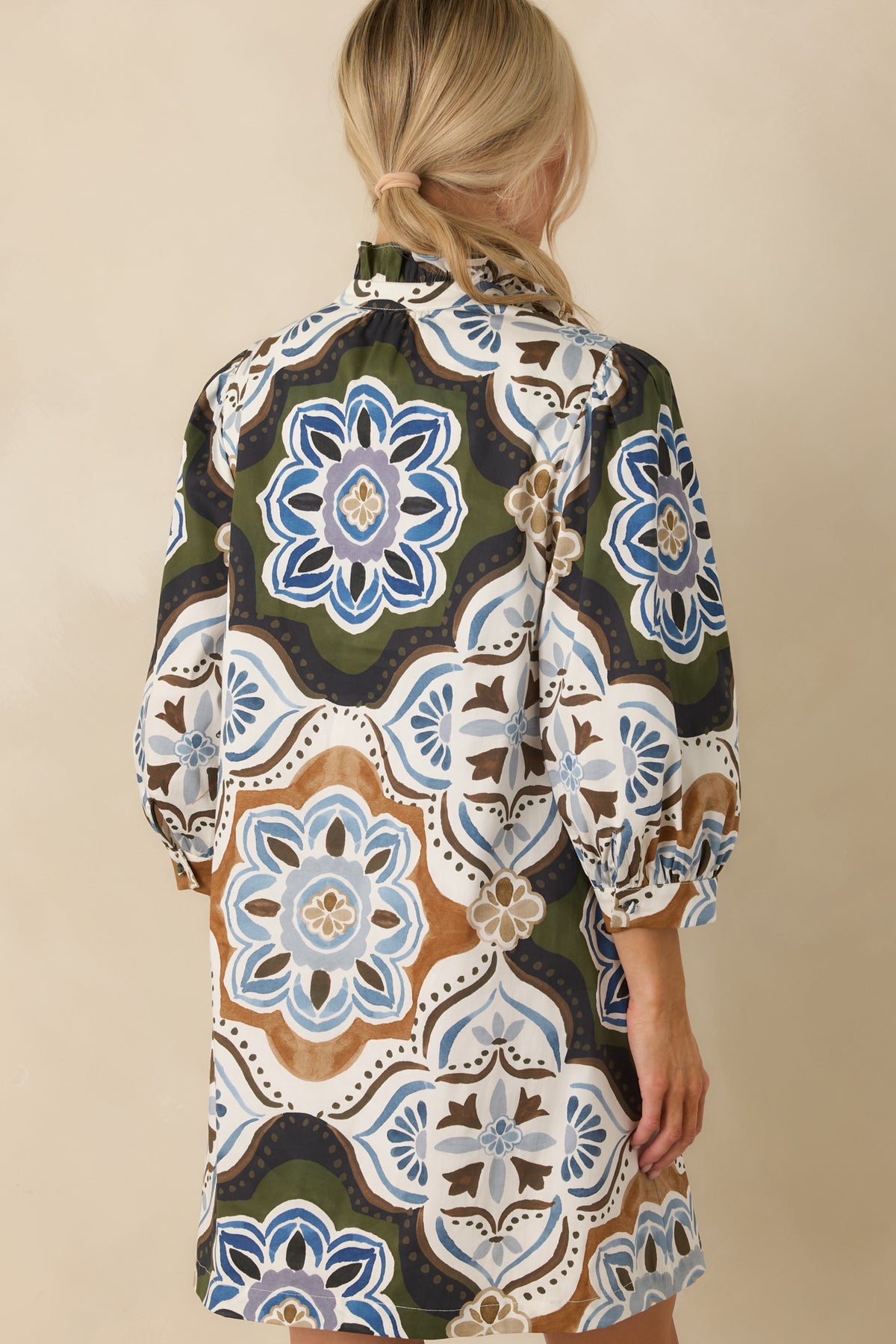 Rear view of the shift mini dress showcasing its oversized medallion print and relaxed silhouette.