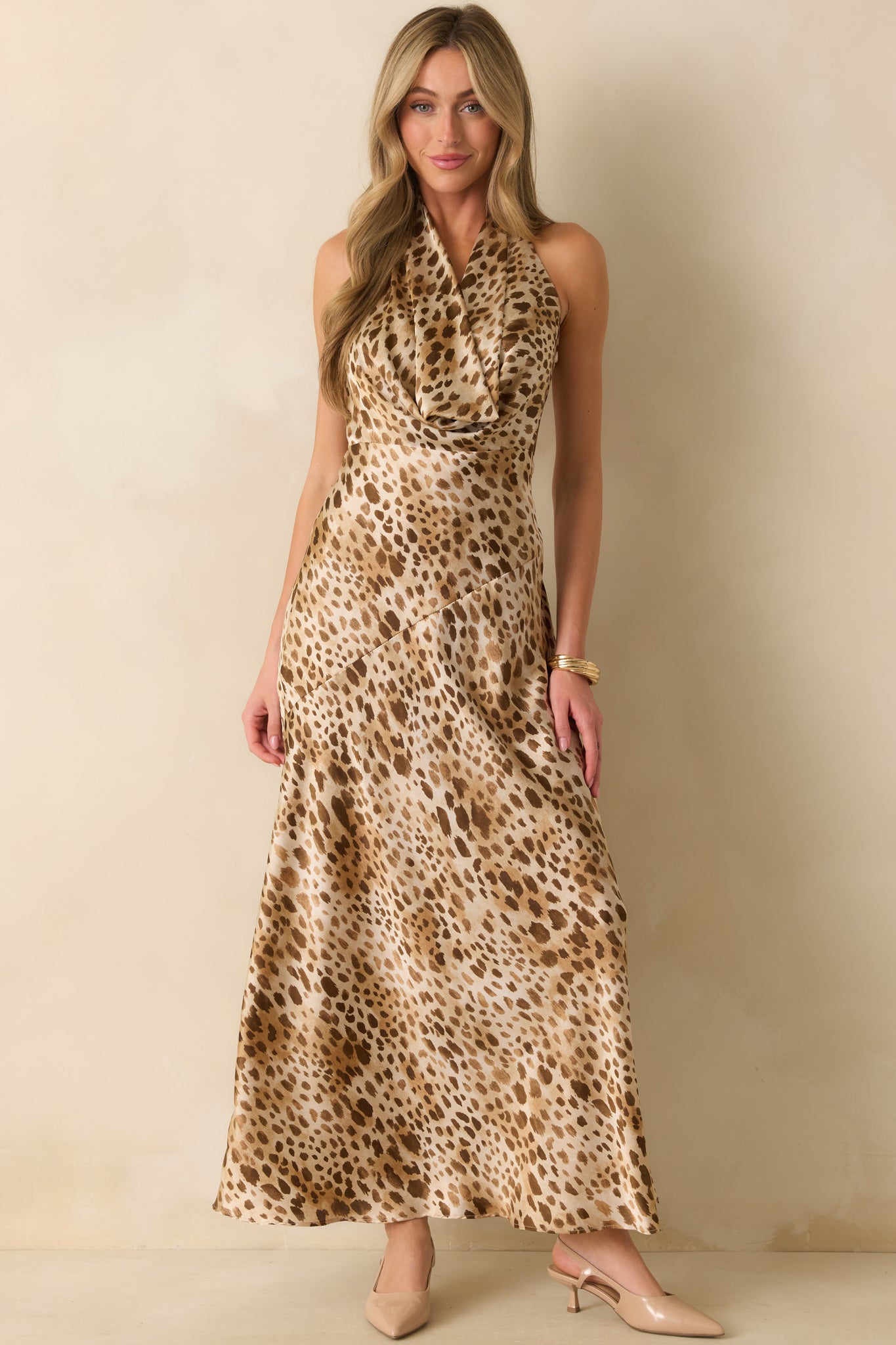 Shiny satin tan leopard print dress featuring a fitted waist and elegant halter style, highlighting the draped front detail.