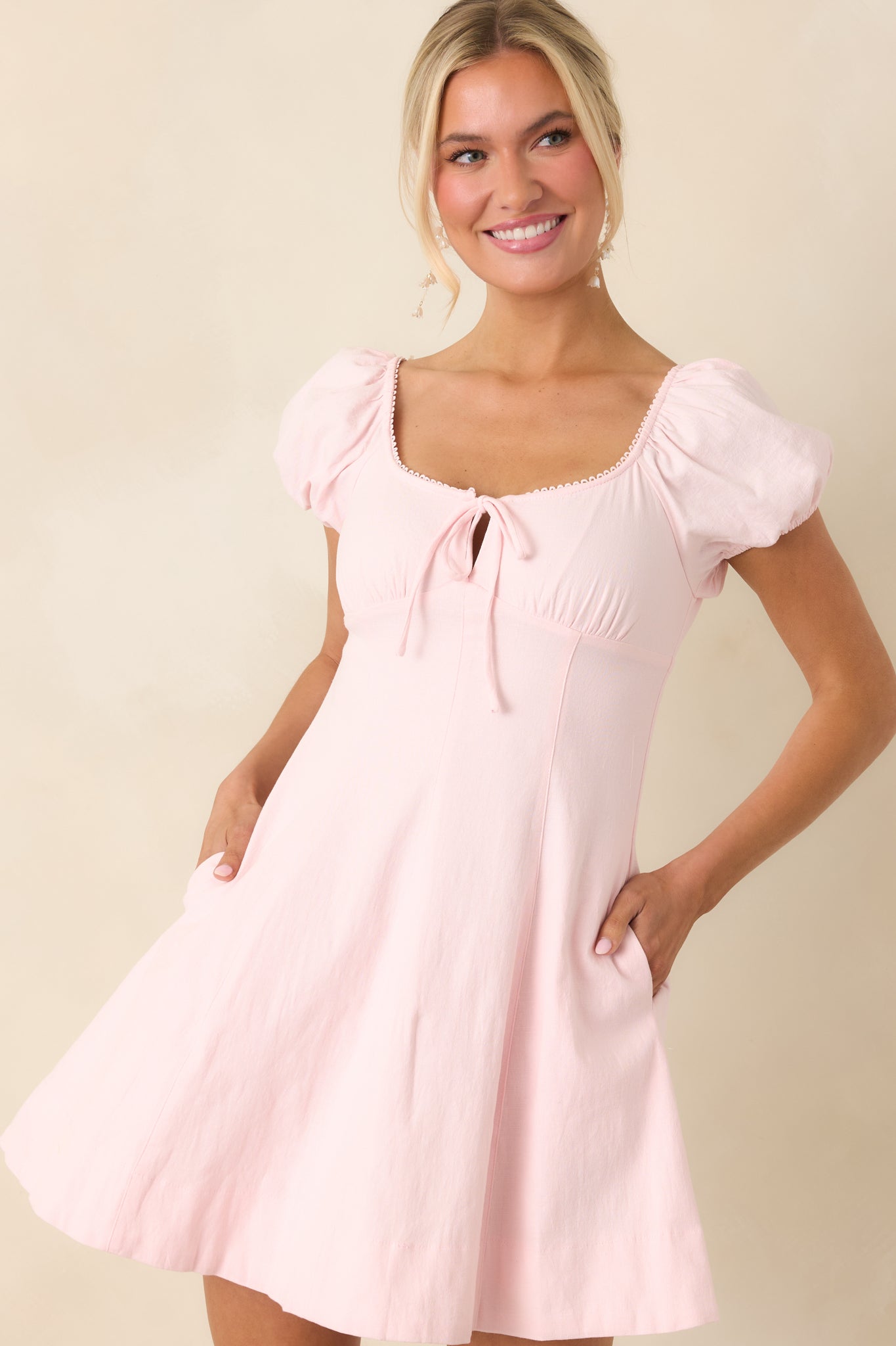 Short puff sleeves with elastic cuffs in a soft peony pink cotton fabric.